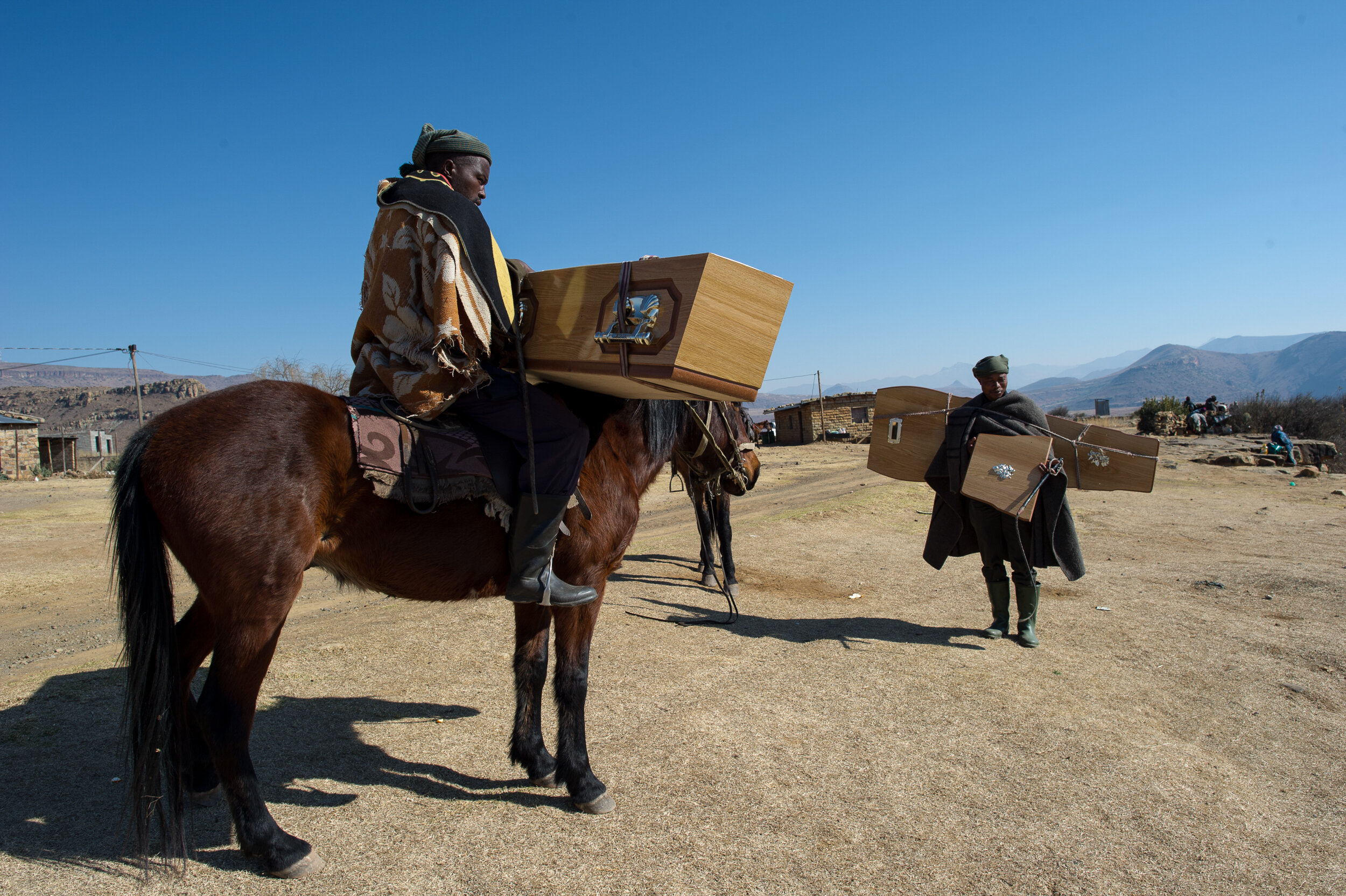  15 July 2011. White Hill, Lesotho. Crossing the Senqu river on horseback is only possible in winter, before the rainy season makes it impossible to cross. These two men are collecting a coffin for the burial of an elderly family member in their vill
