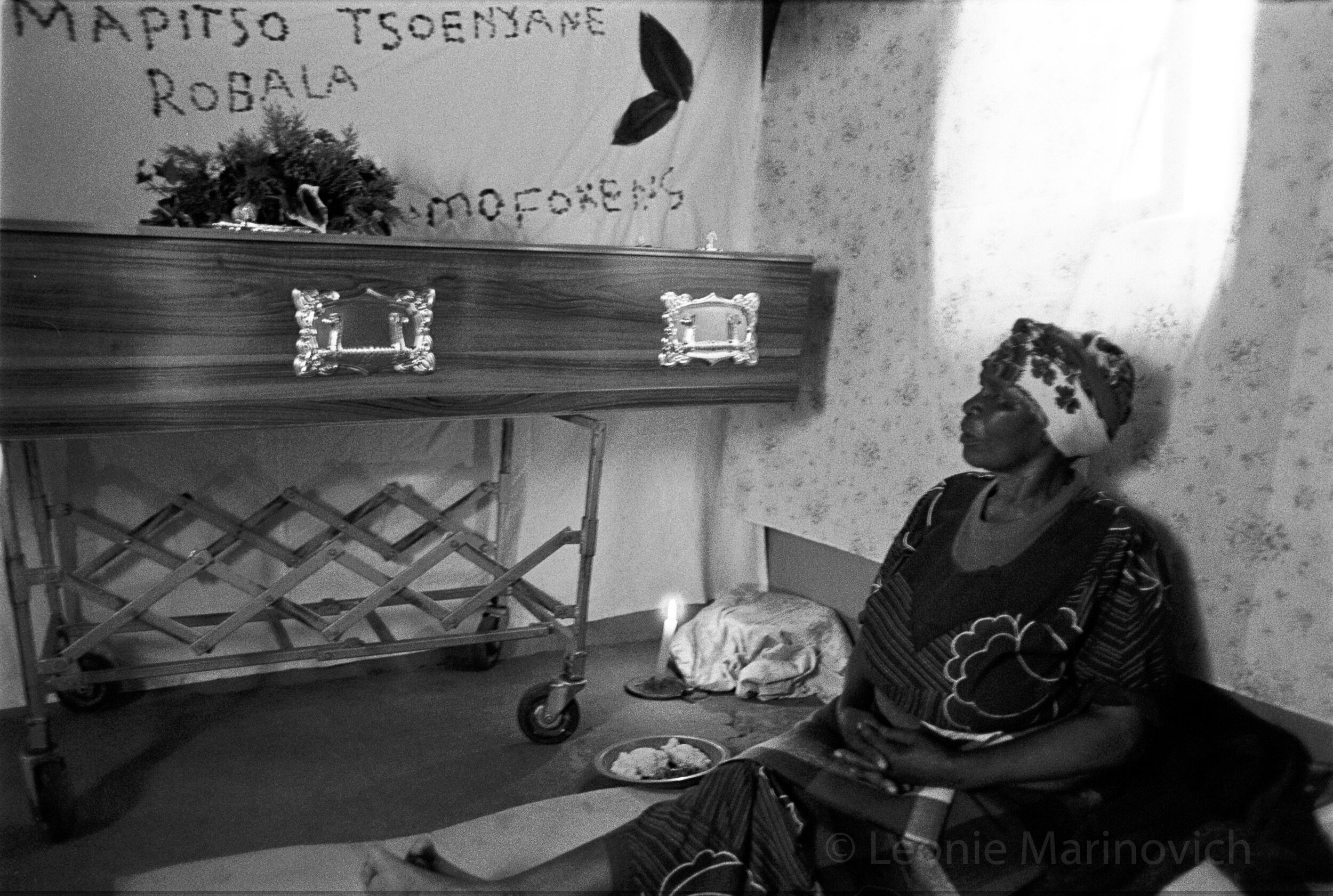 Female relatives keep watch over the coffin of a young woman who succumbed to Aids-related illnesses. 2002. Photo Leonie Marinovich