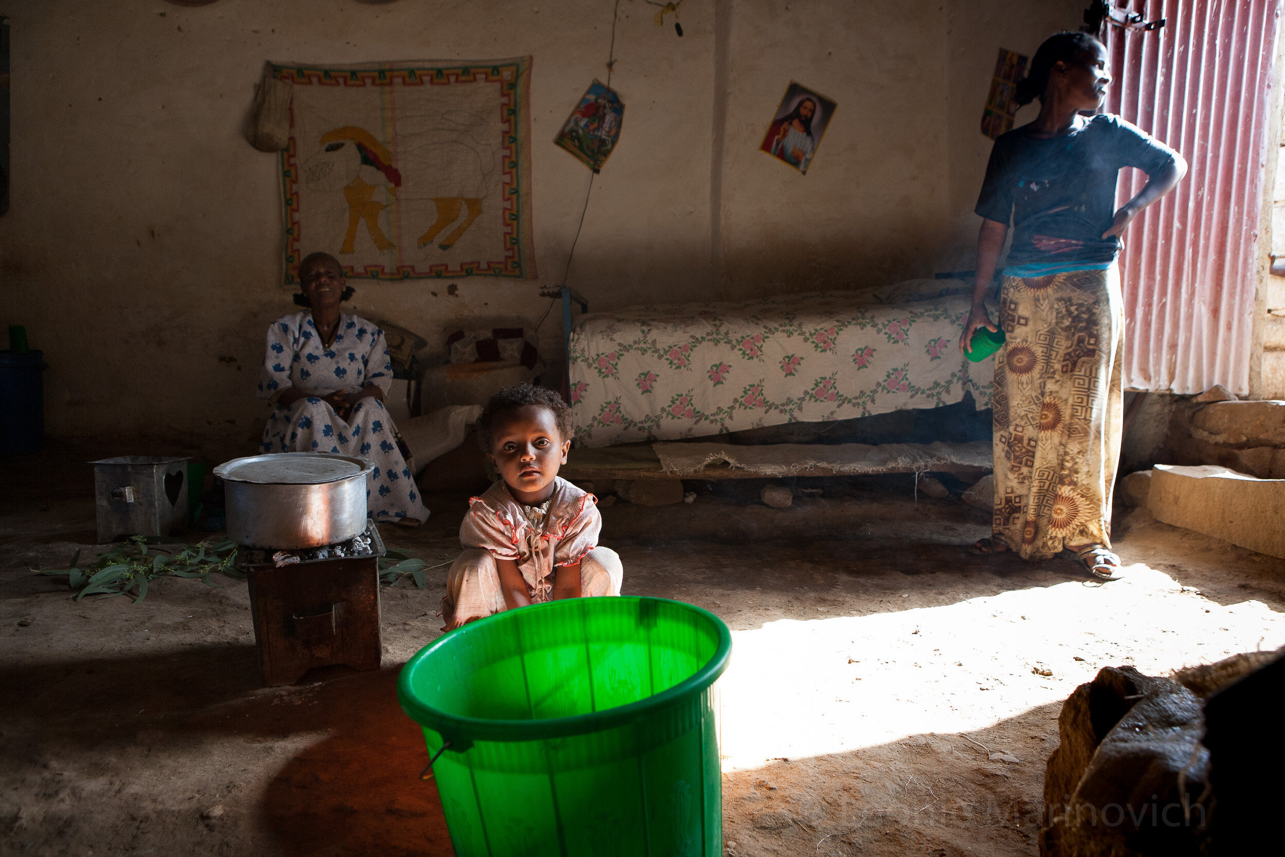  April 2010, Hawzen Town, Tigray, Ethiopia. Kemlem Waldegerima (60) with her daughter, Tsiga Alem (22) and granddaughter, Kissanet Kiday (5). They make sua to sell to townspeople and serve coffee. 