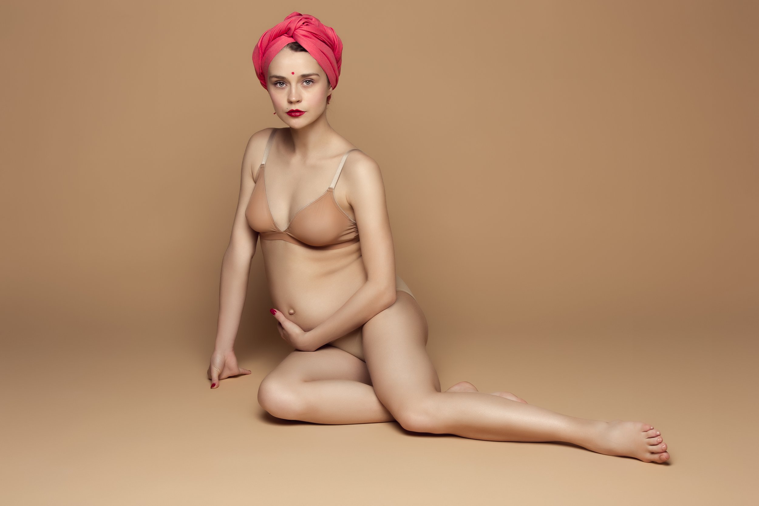 young-beautiful-pregnant-woman-sitting-on-brown-ba-2021-08-26-17-42-51-utc.jpg