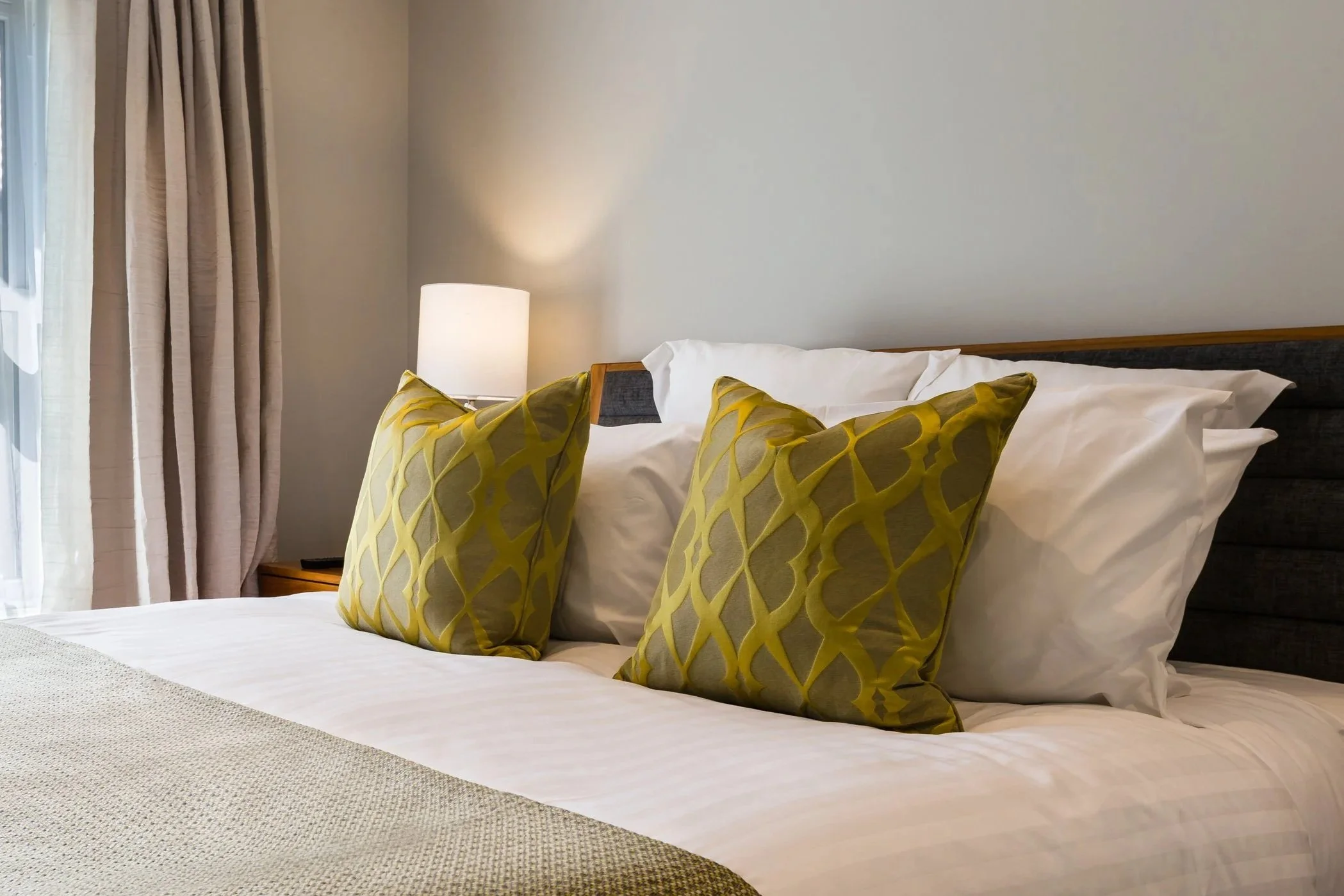 A freshly made bed with crispy white linen at Mangapapa Hotel, Havelock North