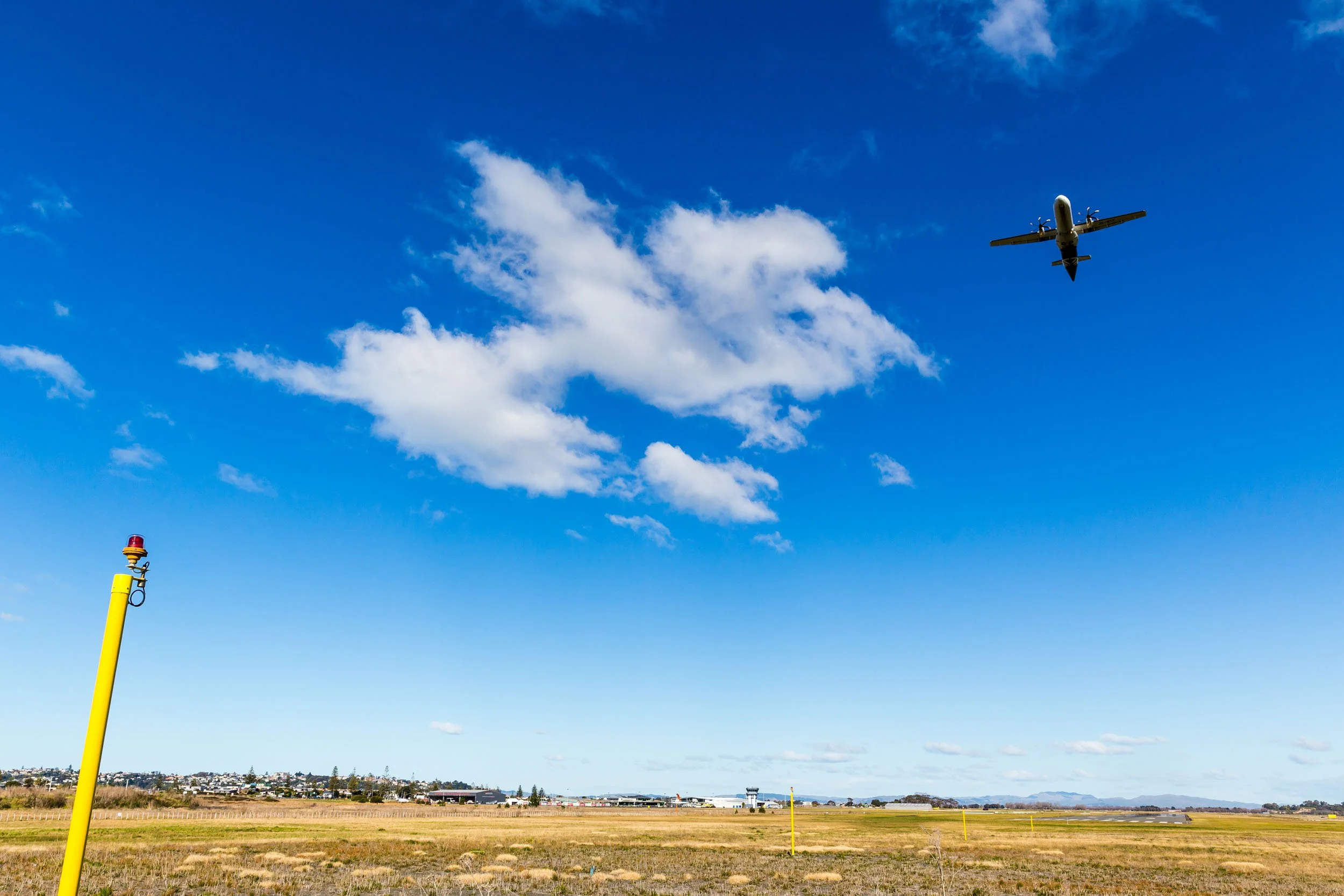 An Air New Zealand plane taking off on a sunny, blue sky day