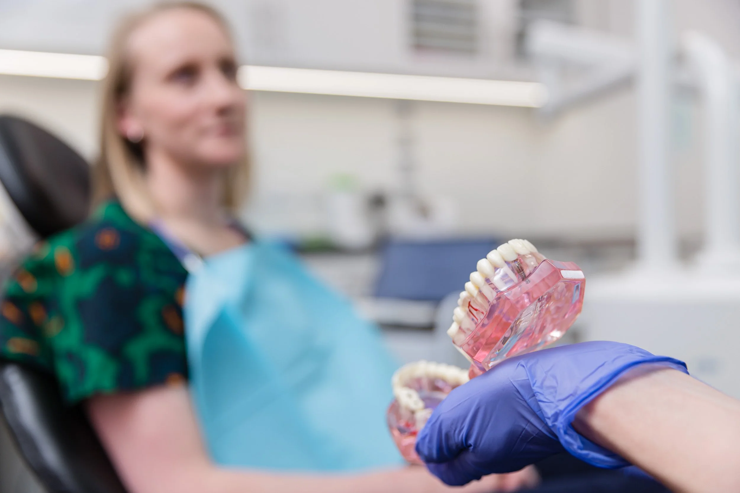 A dentist showing a patient a set of false teeth 