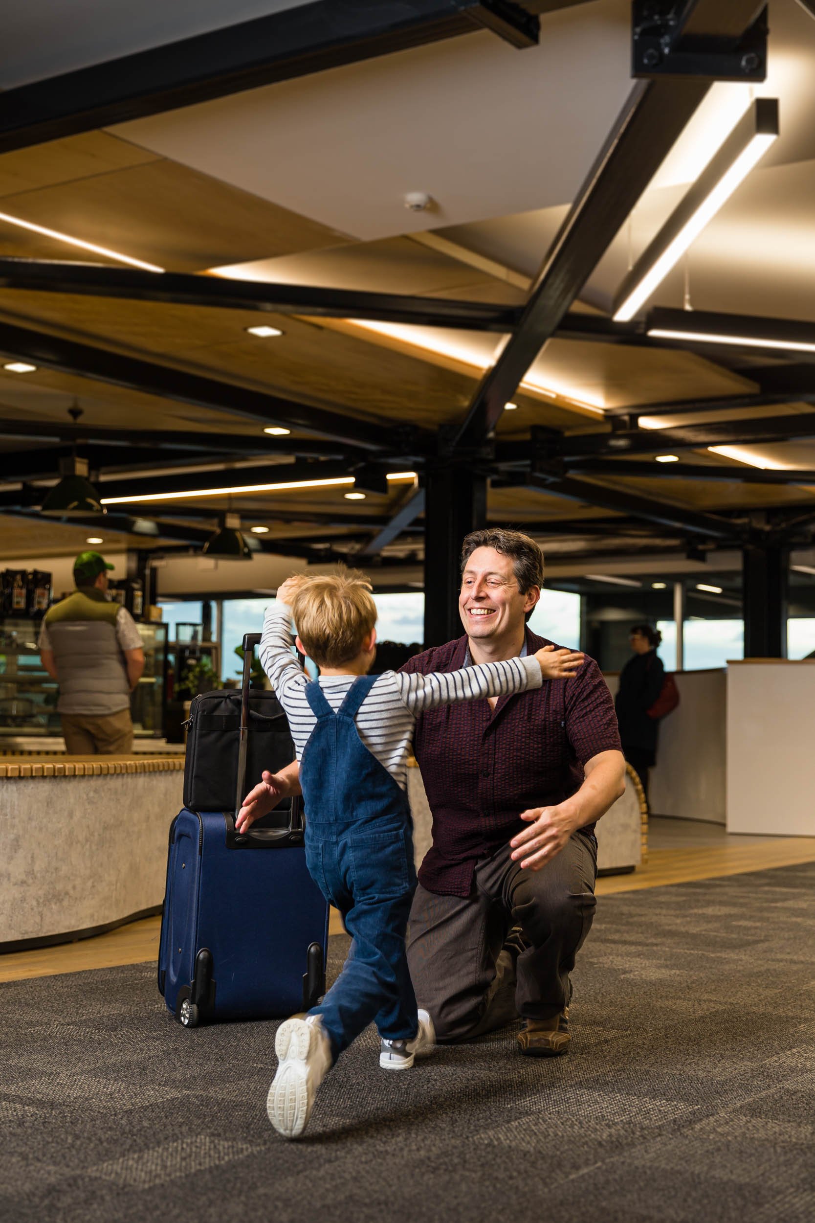 A child running into his Fathers arms at Hawke's Bay Airport
