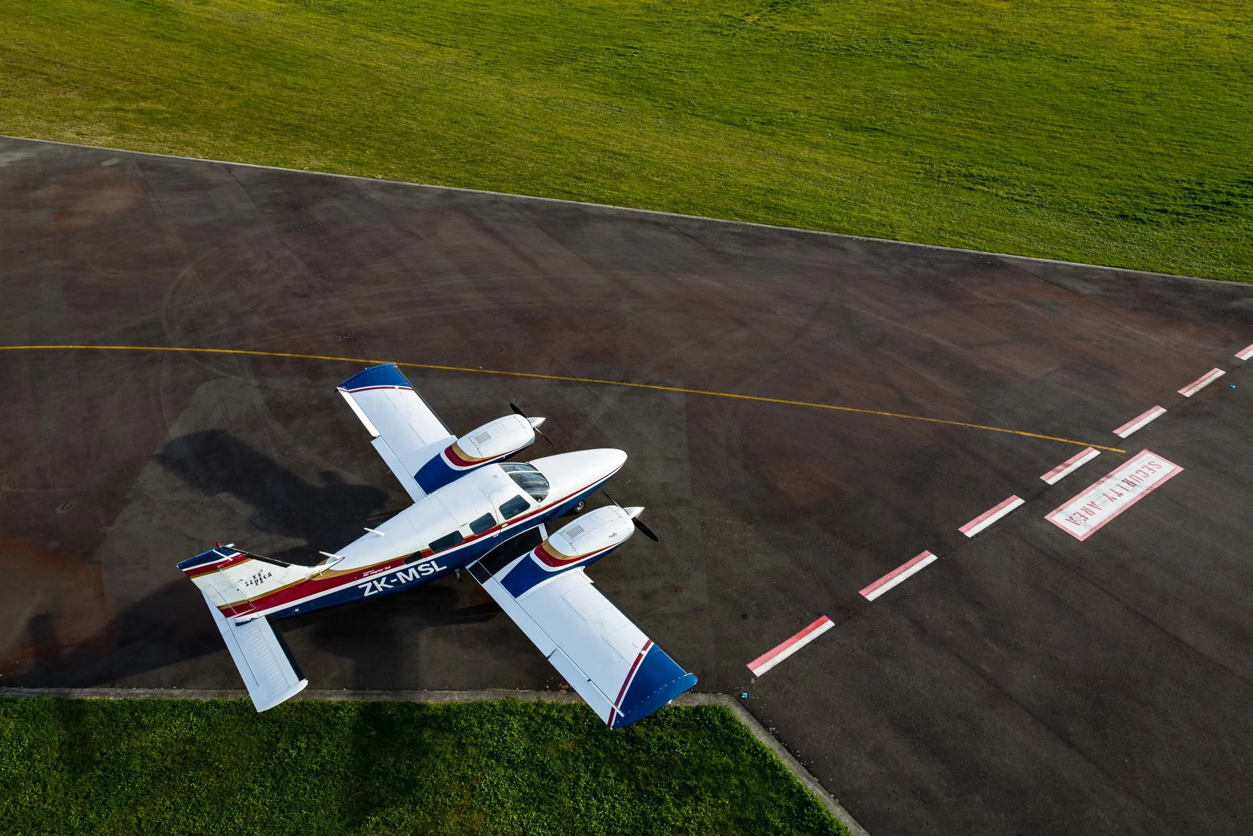 An elevated view of a light aircraft parked on the tarmac at Hawke's Bay Airport