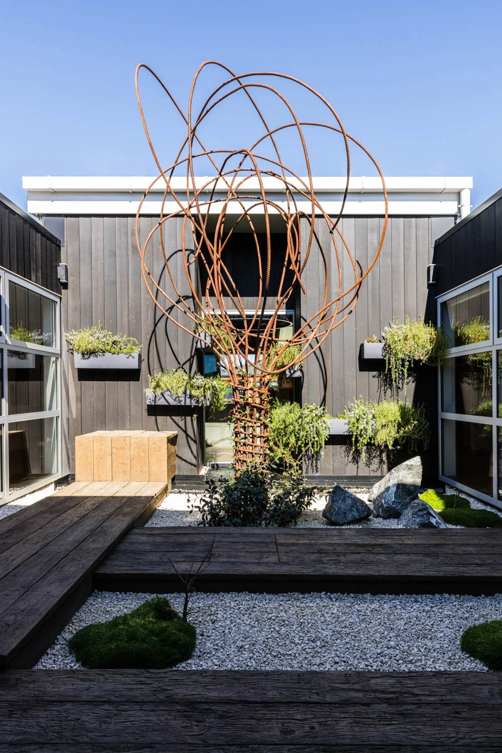 Landscaped courtyard area with reinforcement steel sculpture