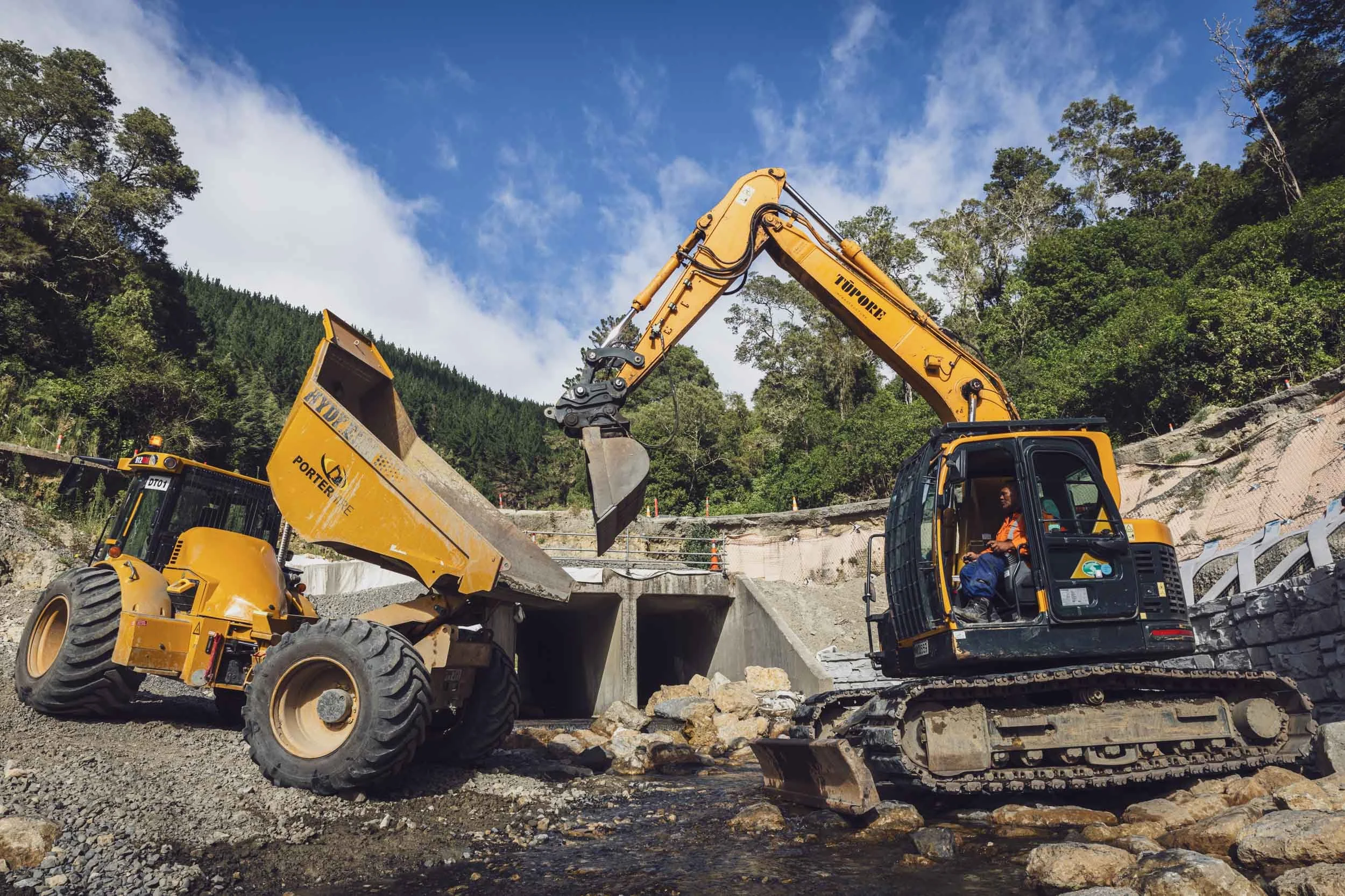 A yellow tipper truck unloading