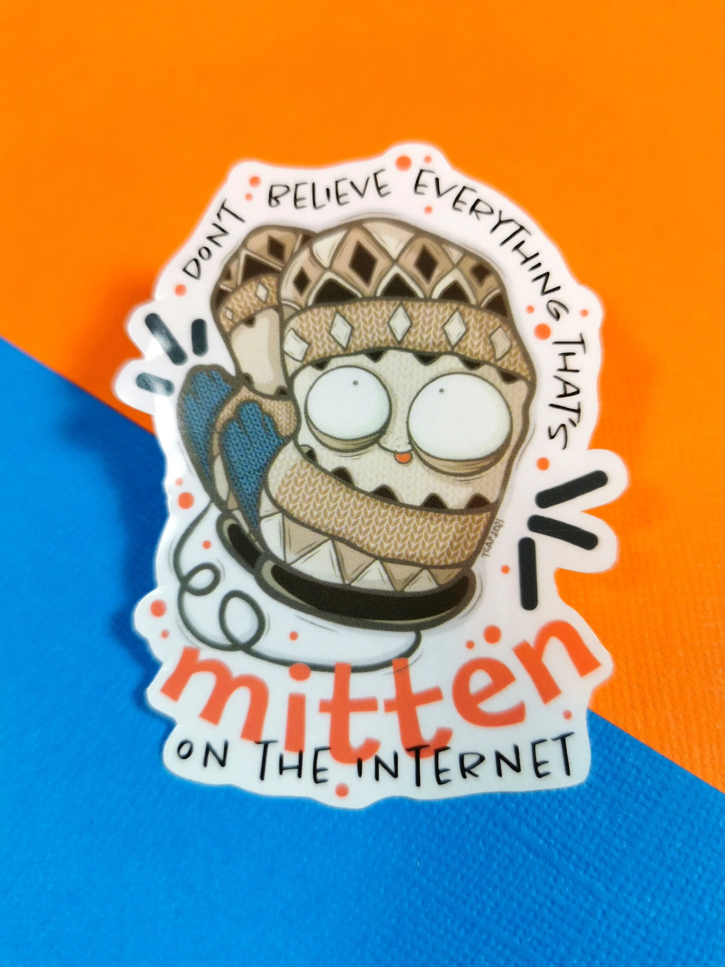 sticker featuring Bernie Sanders mittens laying on a orange and blue background