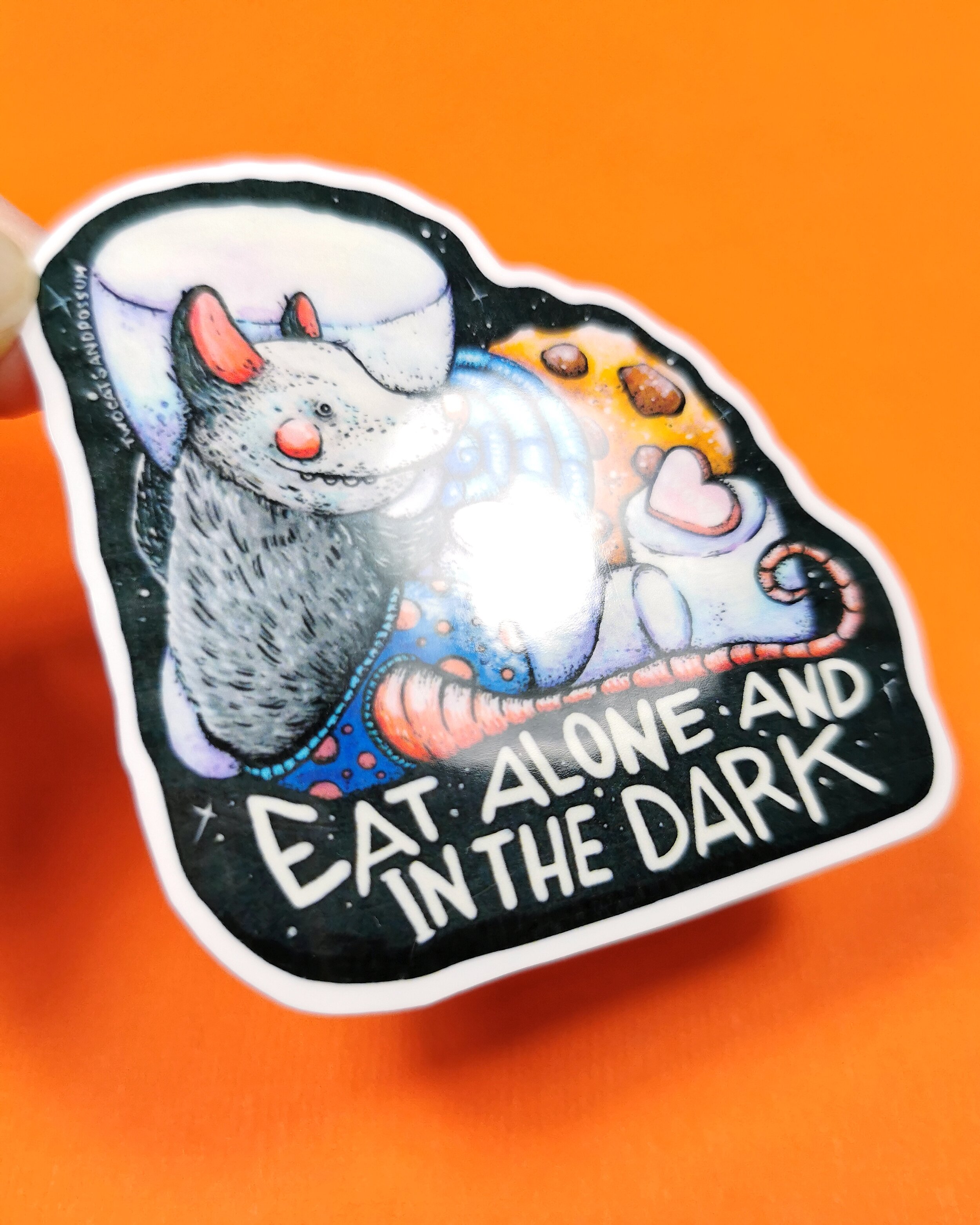 glossy vinyl sticker with cute opossum illustration on it