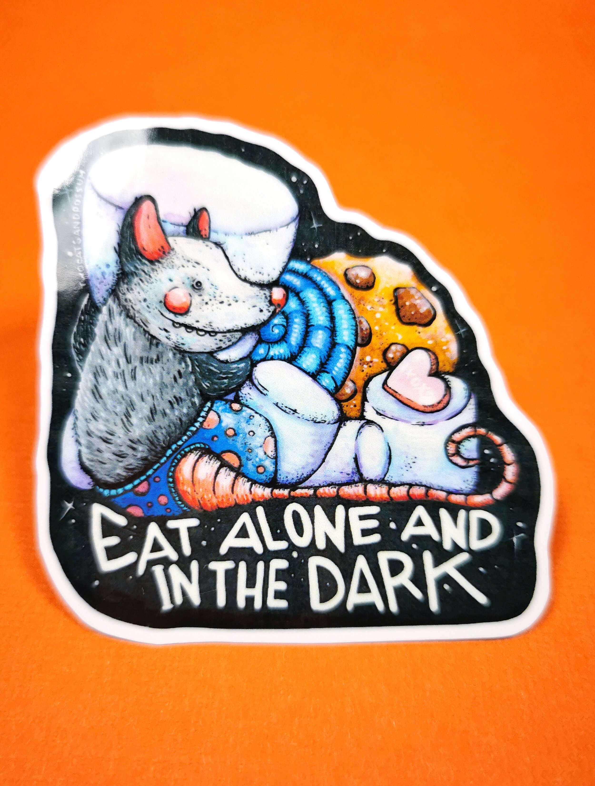 glossy sticker showing cute possum with sweets