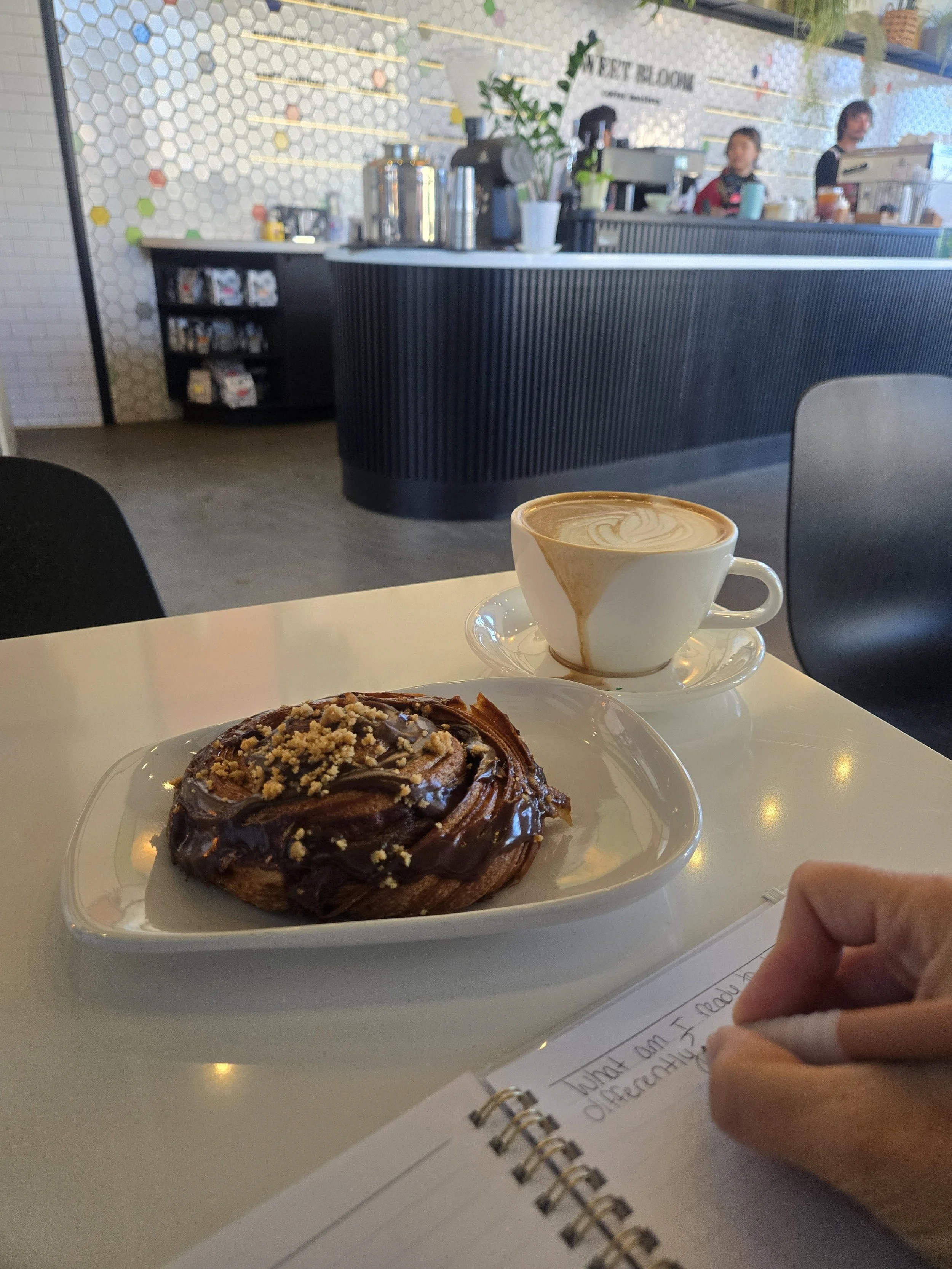 Journal, coffee and handwritten notes representing in-person mindset coaching in the 12-week Integrated AF program in Westminster, Colorado