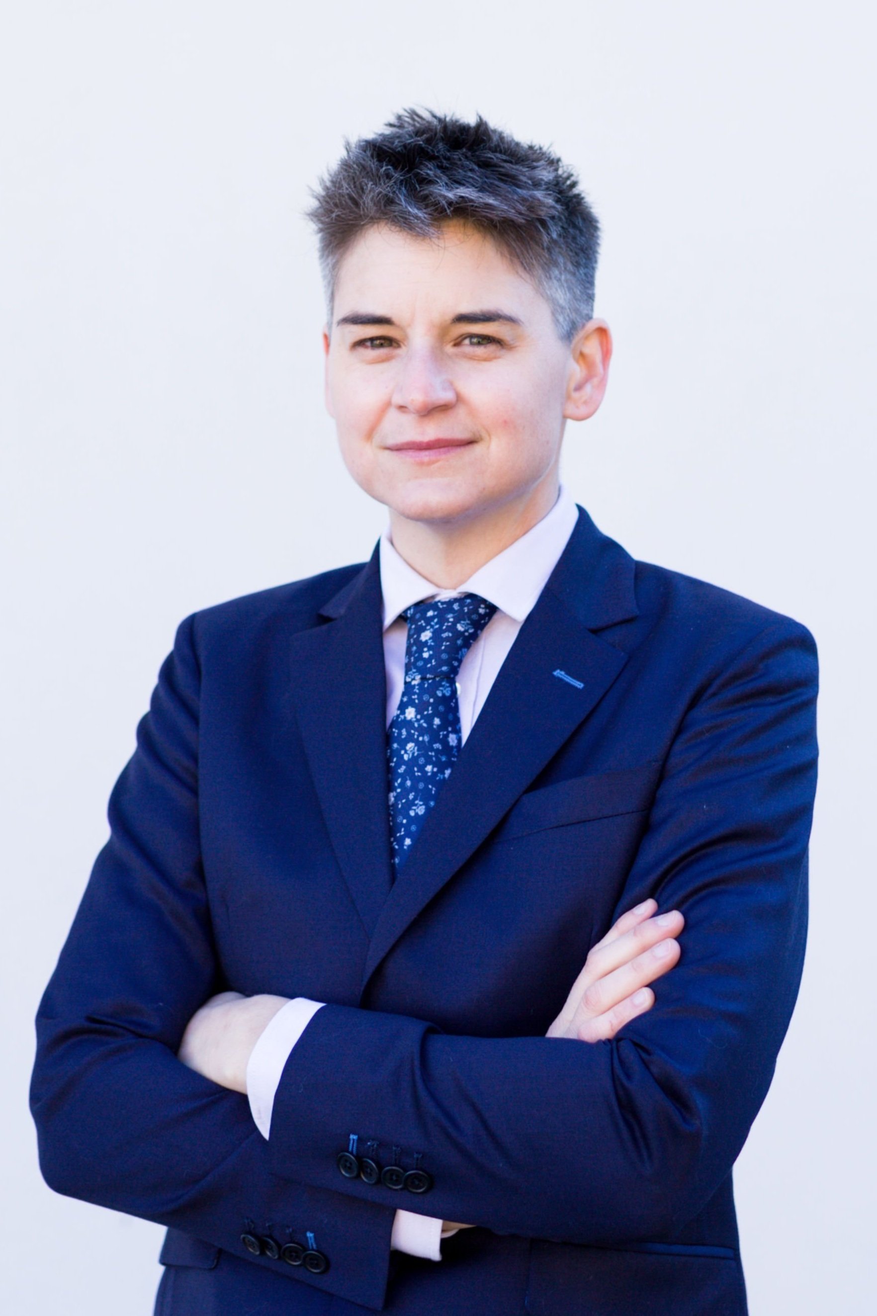 Wilder Clements, employment lawyer, wearing a suit with arms crossed