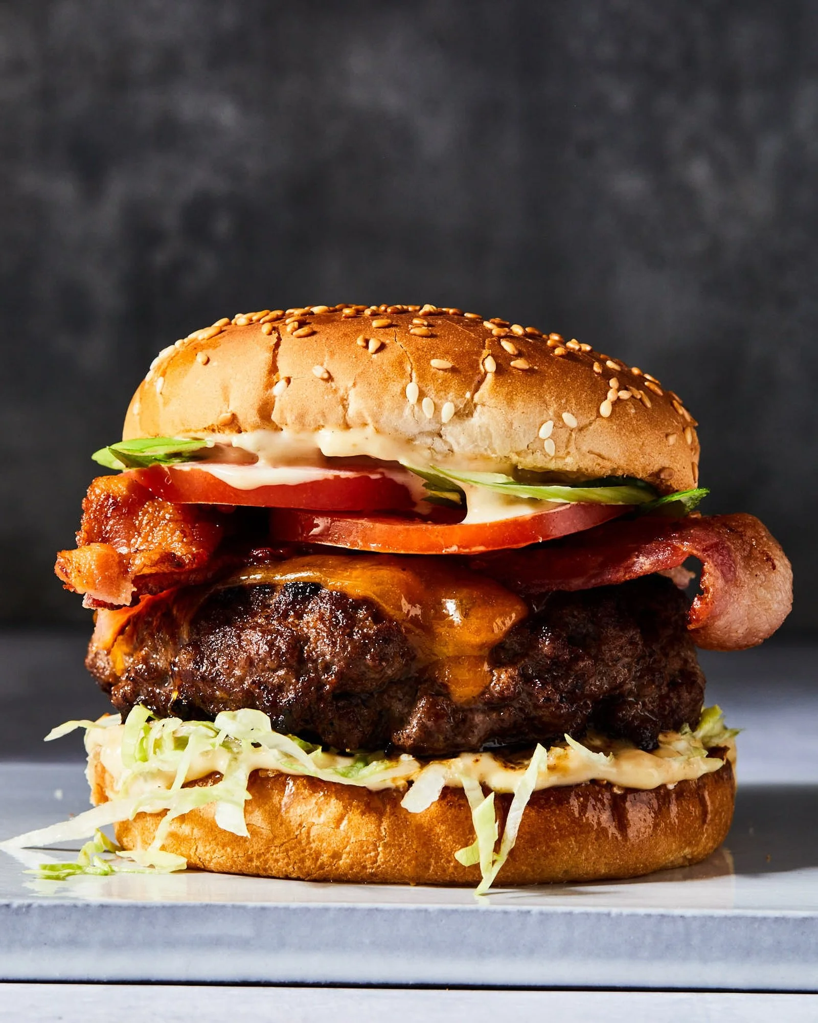 Happy National Burger Day! 🍔 From FAMILY STYLE my Char Siu Bacon Cheeseburger ✨
photography @linda.xiao 
food styling @heysueli 
prop styling @sarah.smart.stylist 
.
.
.
#petersom #familystylebypetersom #nationalburgerday