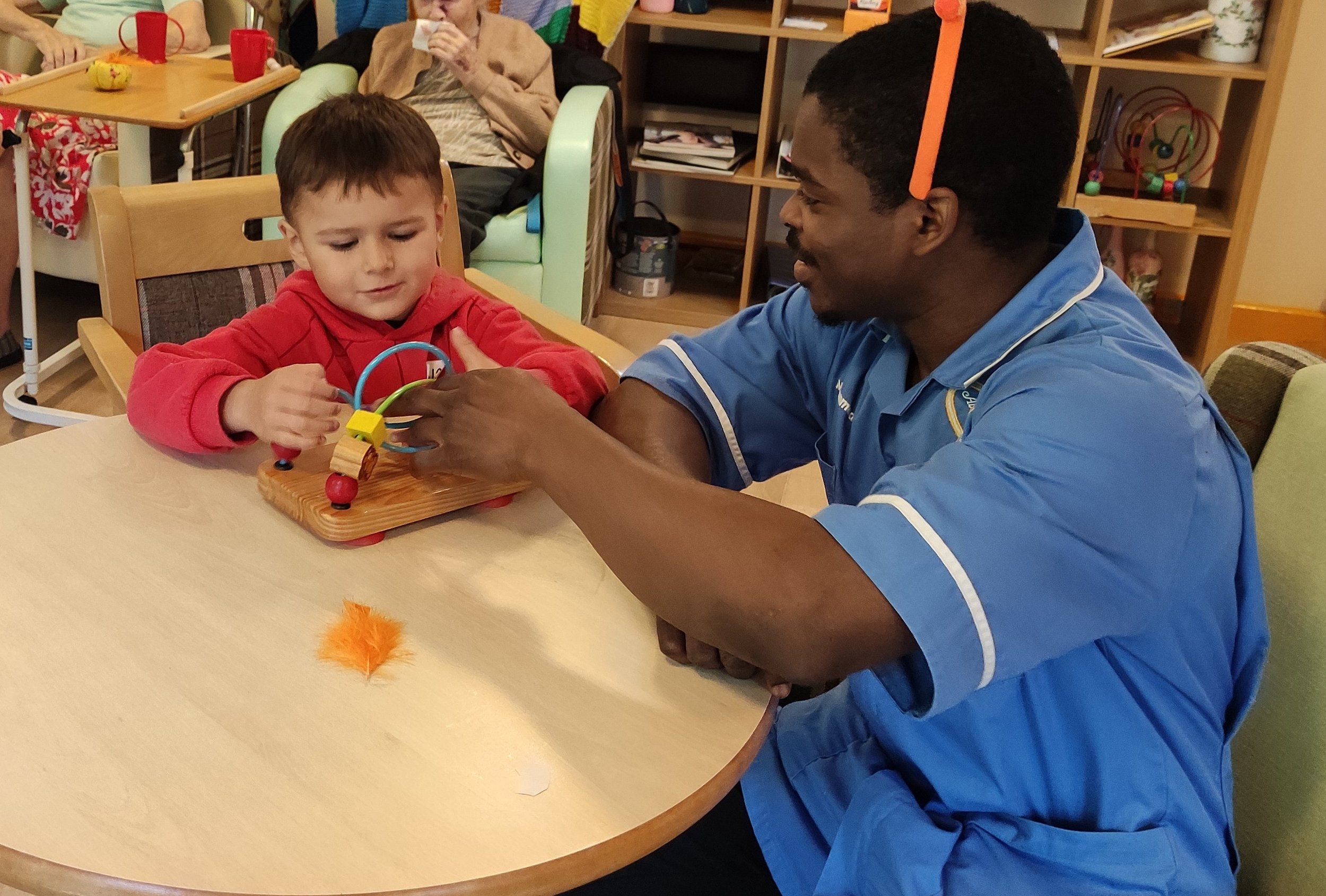 Avalon healthcare assistant Mohammed Oladele with a Little Montessori House pupil.jpg