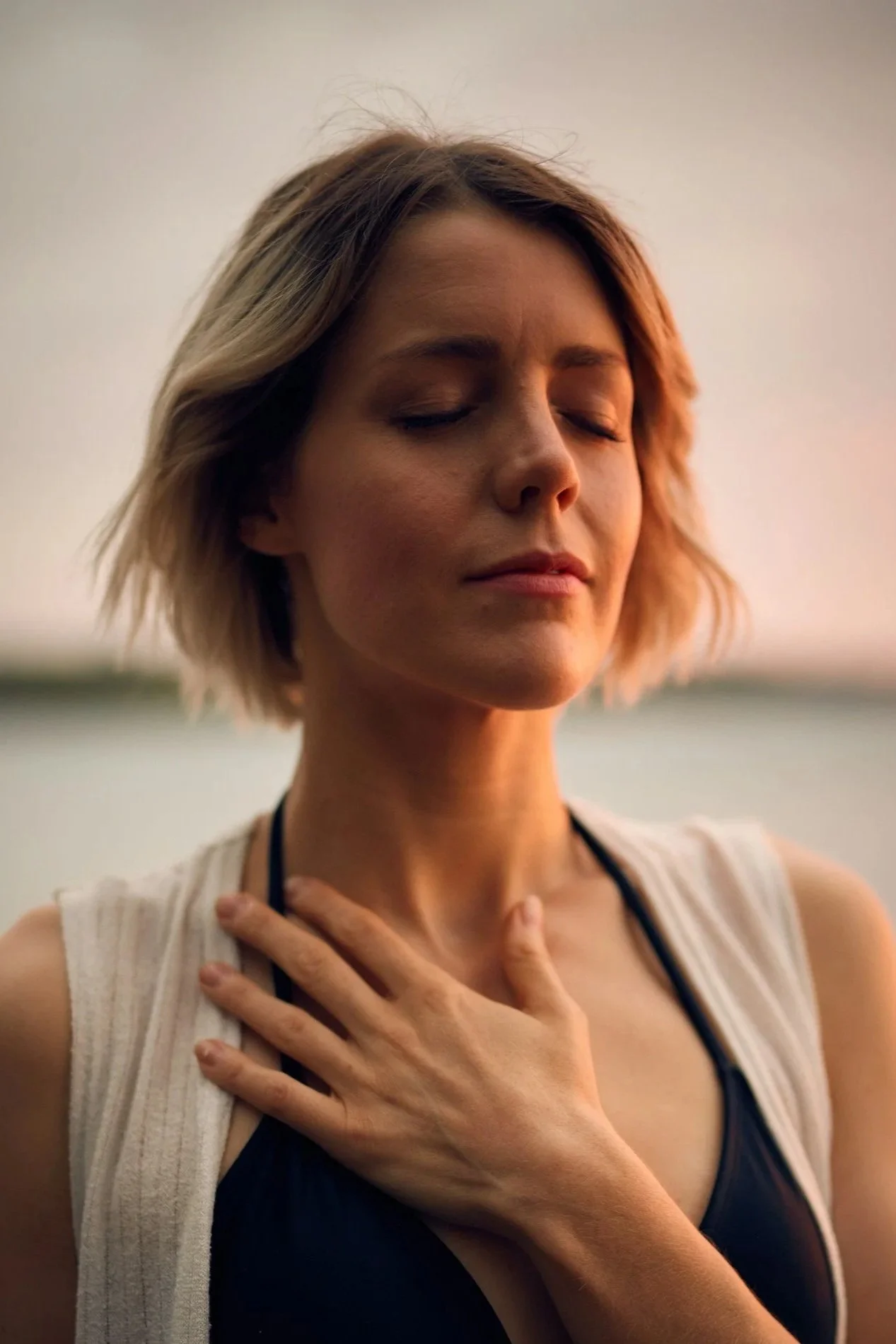 woman breathing deeply with hand on heart