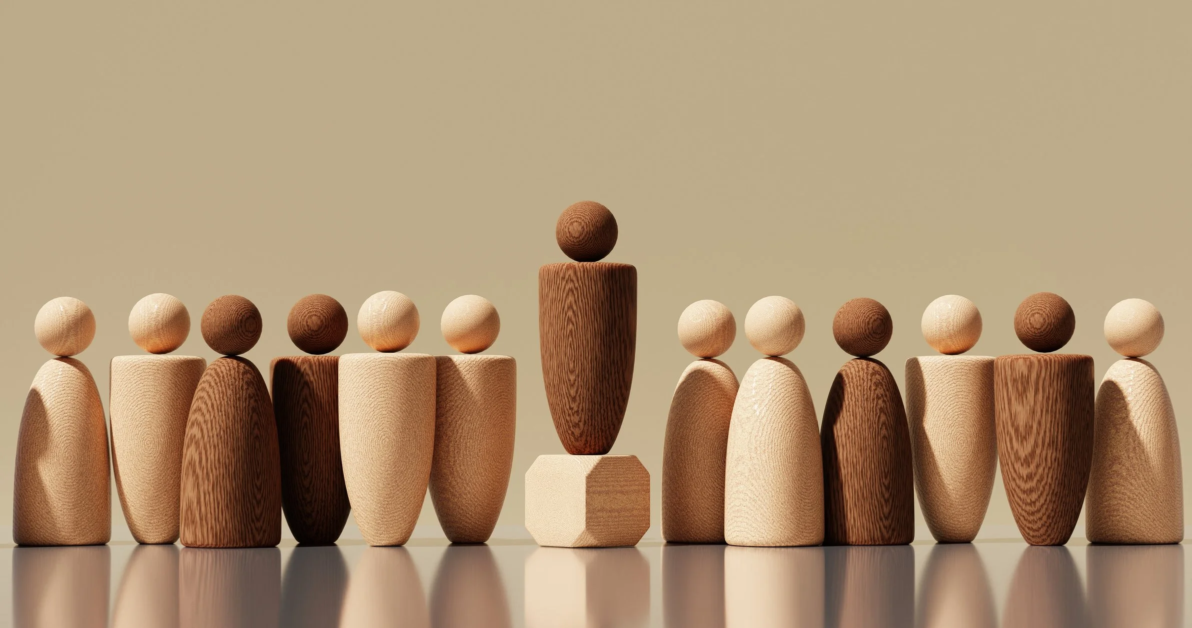 A row of wooden figures with one higher looking like the leader