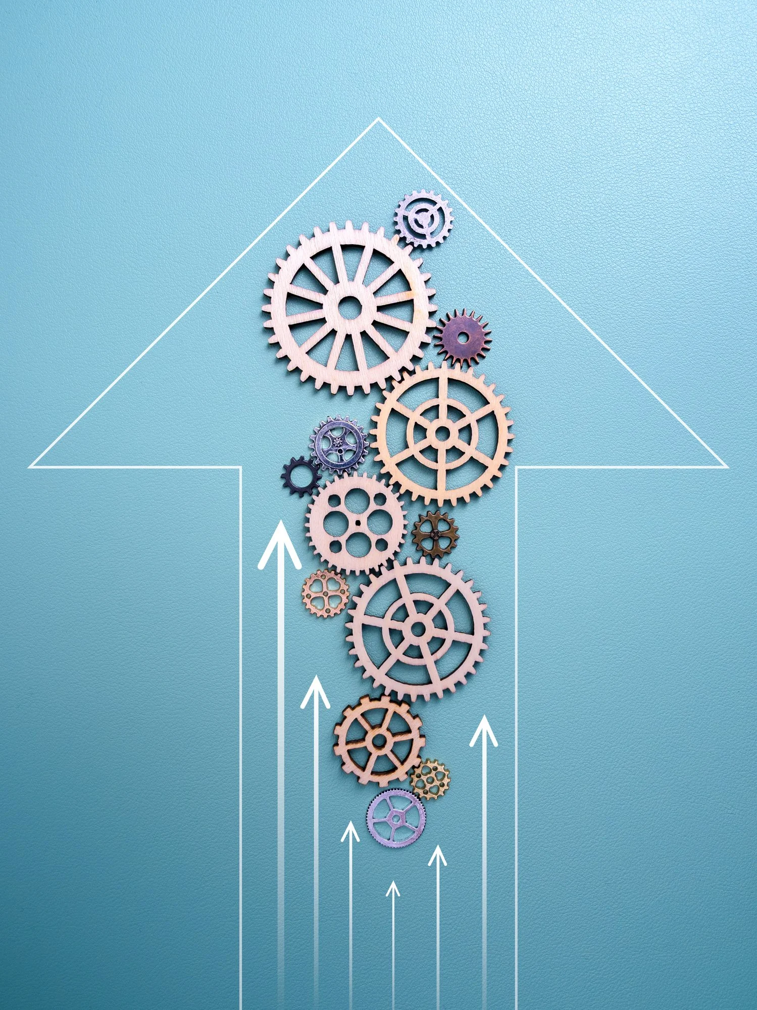 A series of interconnected gears arranged vertically on a teal background with white line and arrow graphics indicating upward movement representing leadership team effectiveness.