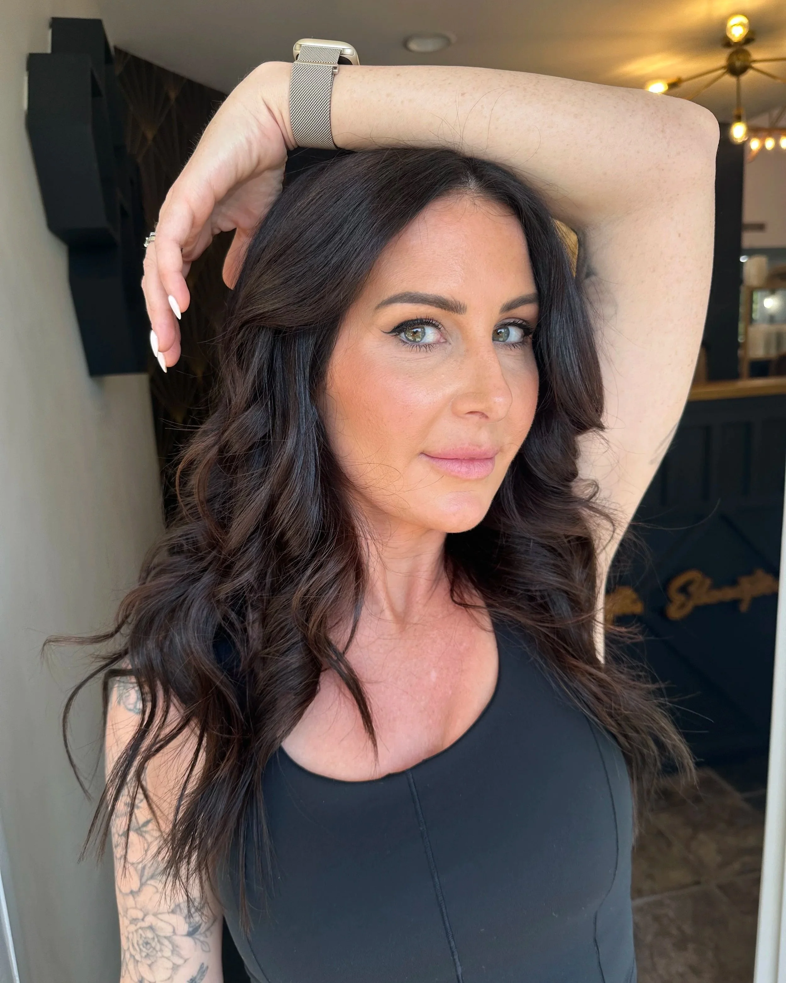 Long brunette hair with seamless extensions for added length and fullness at TEAL Hair & Makeup Studio