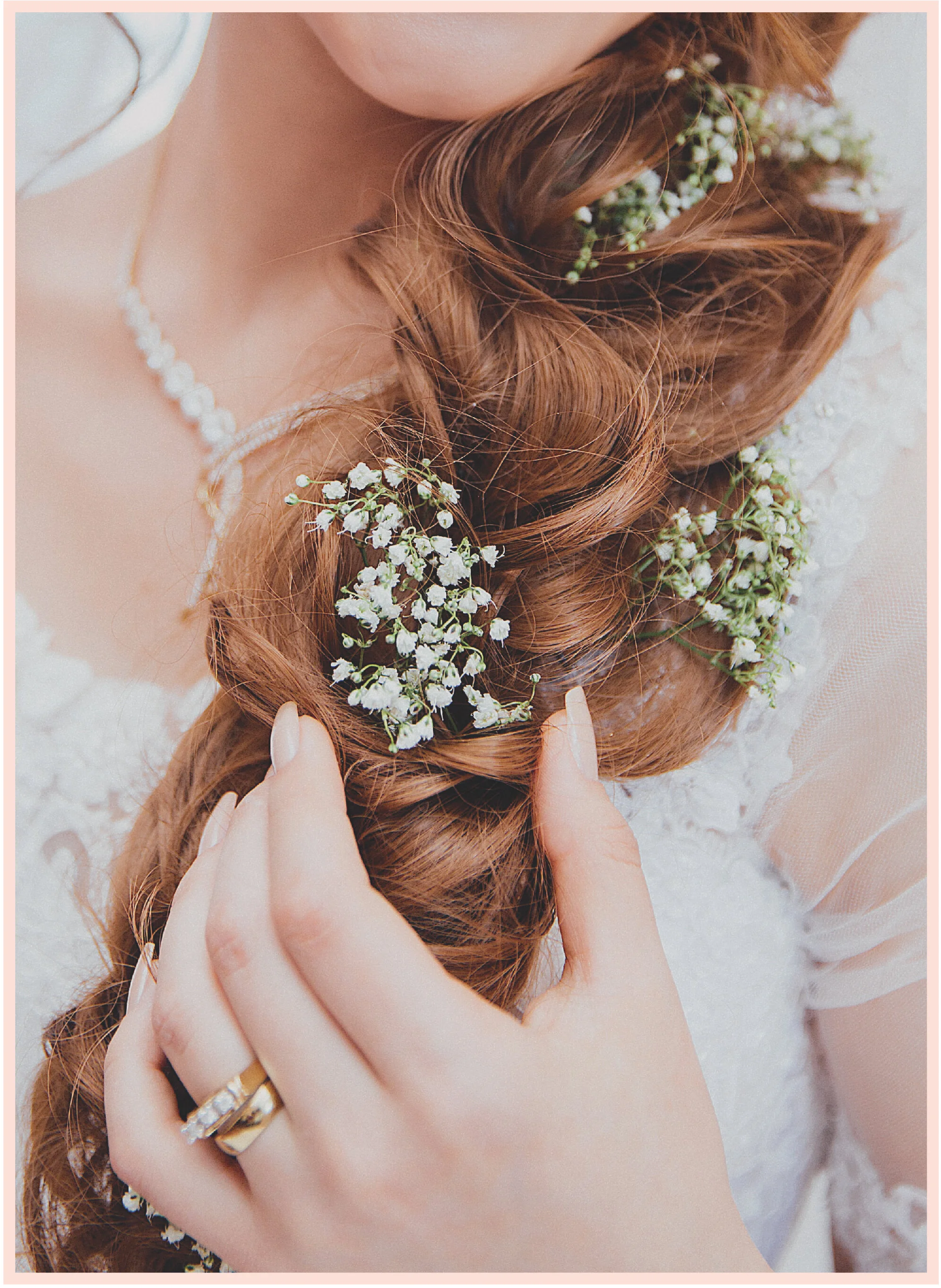 Romantic bridal hairstyle with soft waves and baby's breath flowers by TEAL Hair & Makeup Studio in Lowell, MA