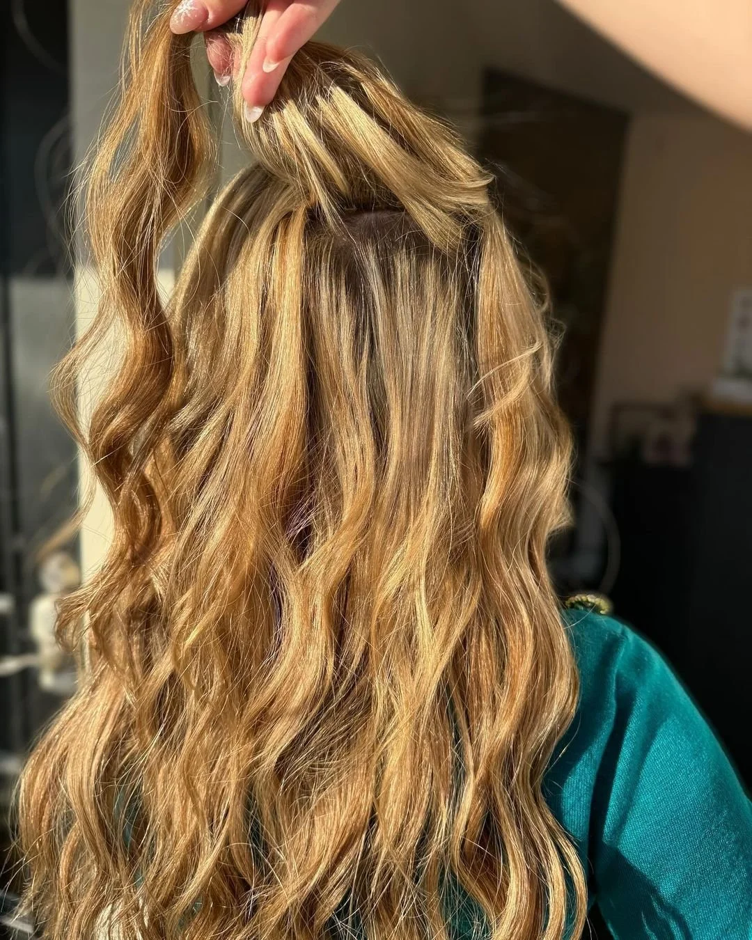 Dimensional blonde hair with seamless extensions for added length and fullness at TEAL Hair & Makeup Studio