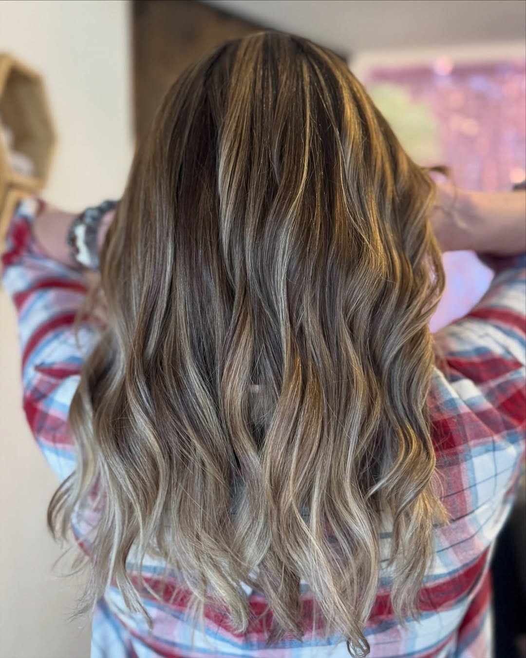 Dimensional brunette hair with soft blonde highlights at TEAL Hair & Makeup Studio