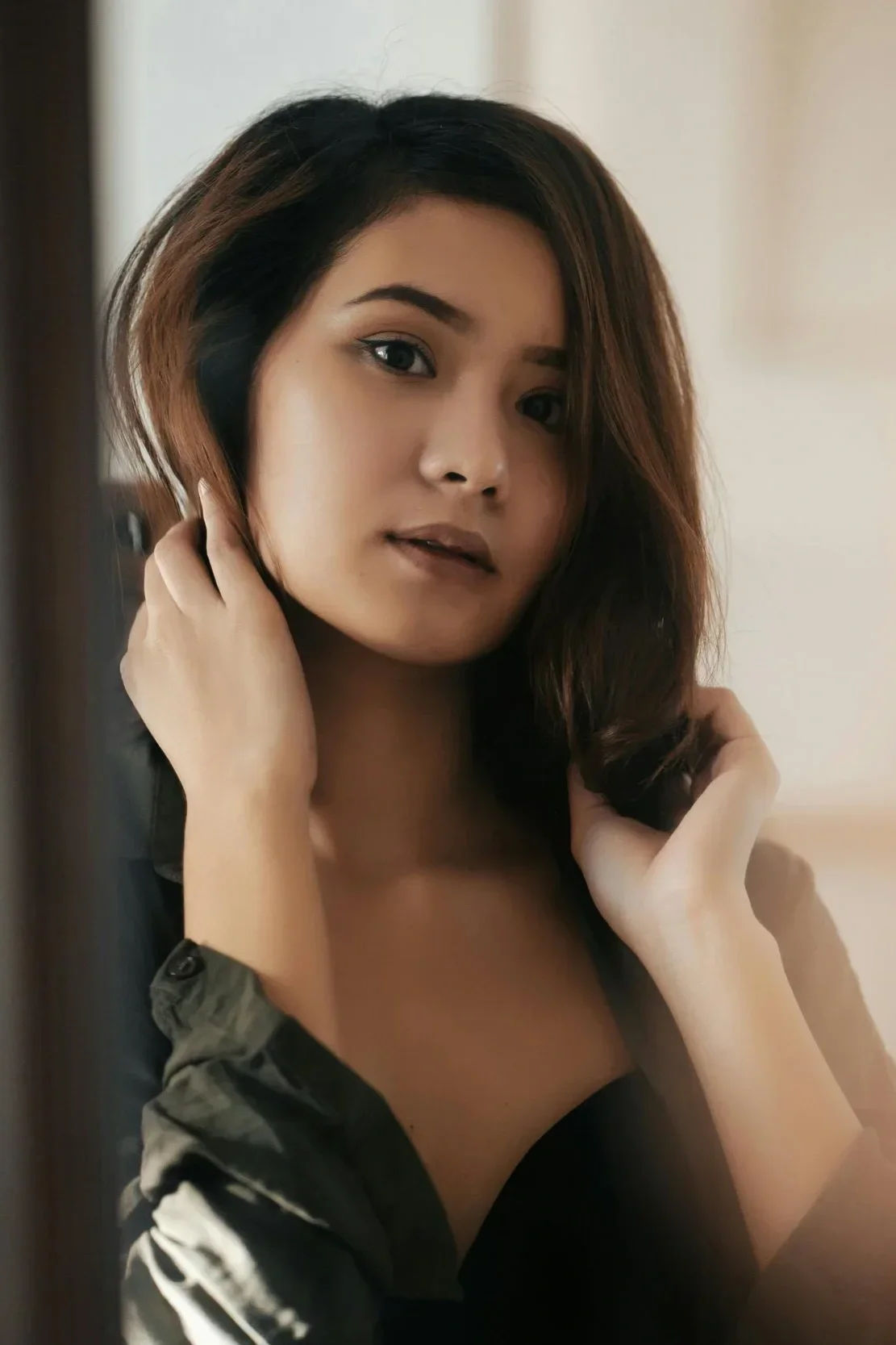 Woman with shoulder-length dimensional brunette hair showcasing a rich natural-looking hair color
