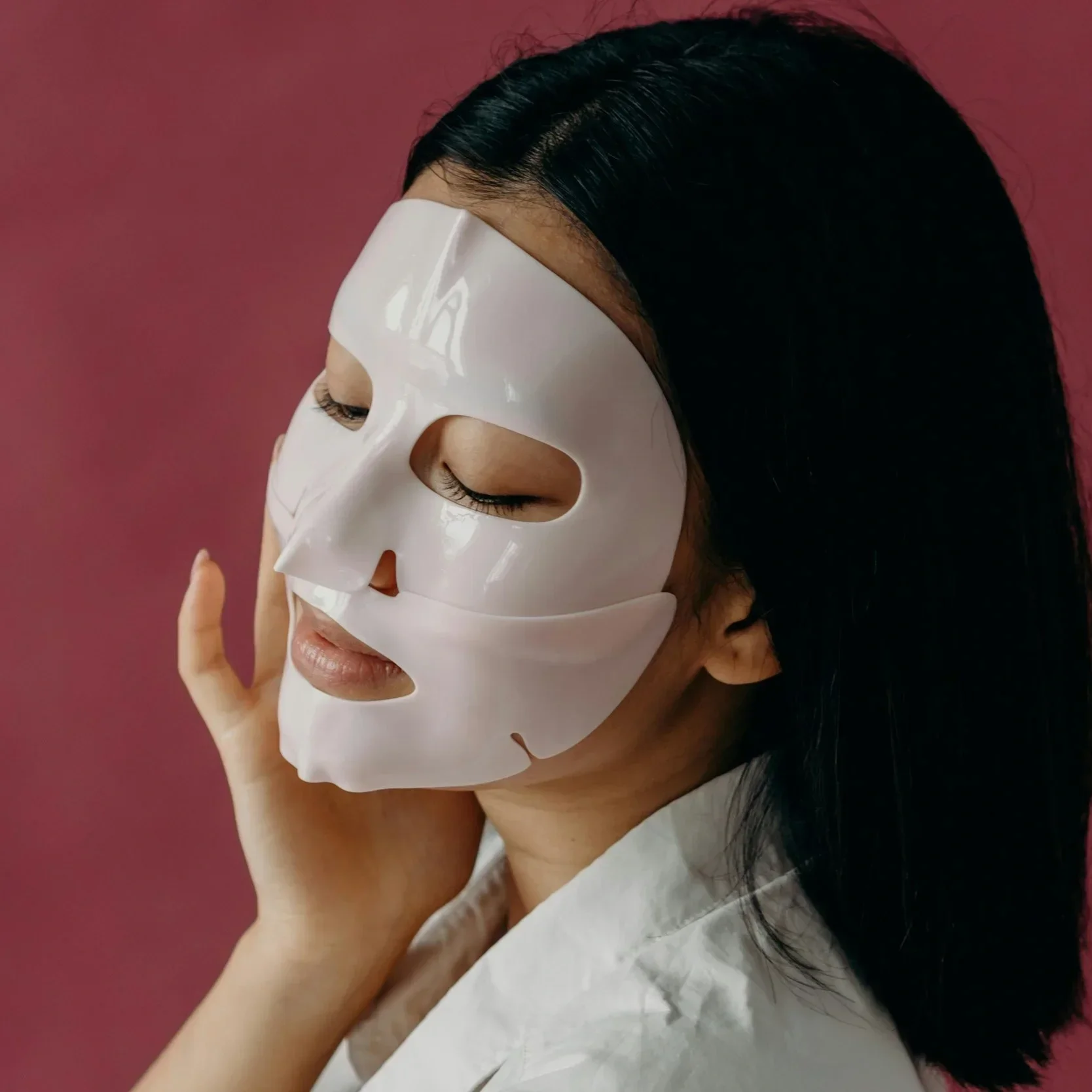 Woman wearing a facial sheet mask as part of a pre-wedding skincare routine