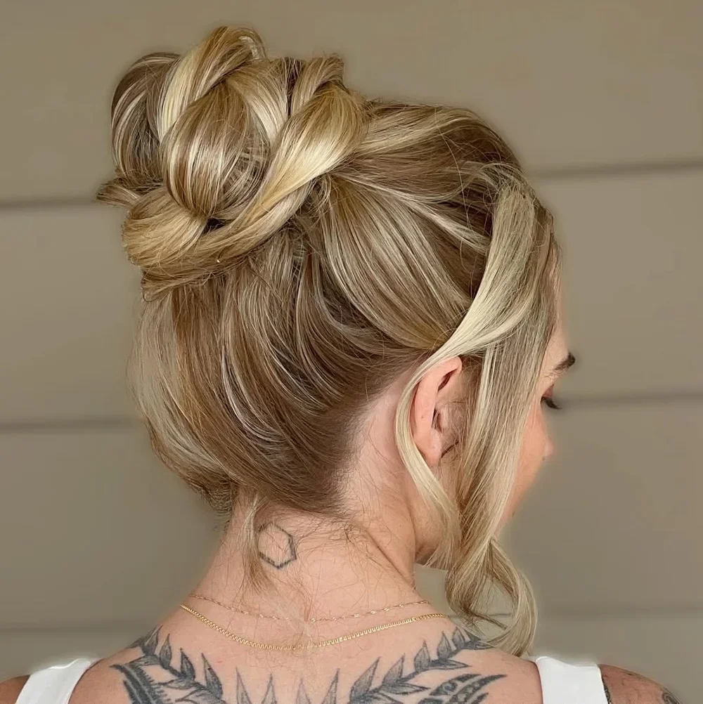Blonde hair styled in an elegant updo with soft face-framing pieces