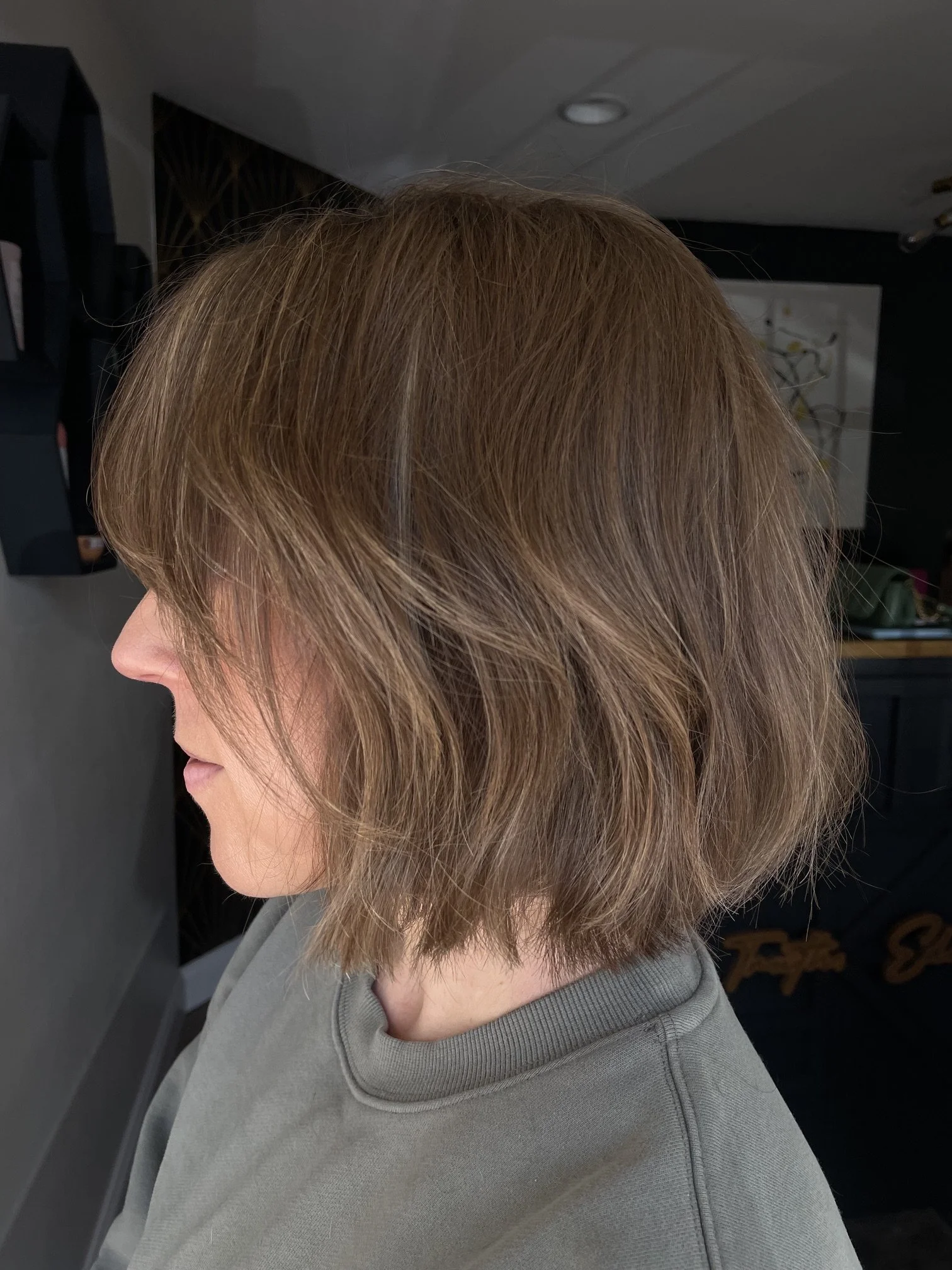 Medium-length layered haircut with soft waves and face-framing pieces around the front