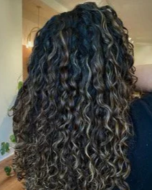 Long dark naturally curly hair with defined curls styled for Teal Studio Curl Style with Optional Education.