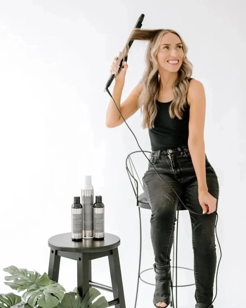 TEAL Hair & Makeup Studio stylist curling long blonde hair