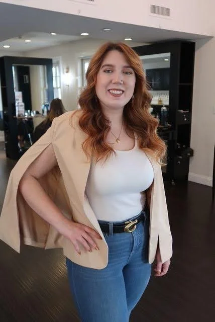 Annie, Teal Studio Level 2 stylist specializing in lived-in color and bridal hair and makeup, smiling inside the salon