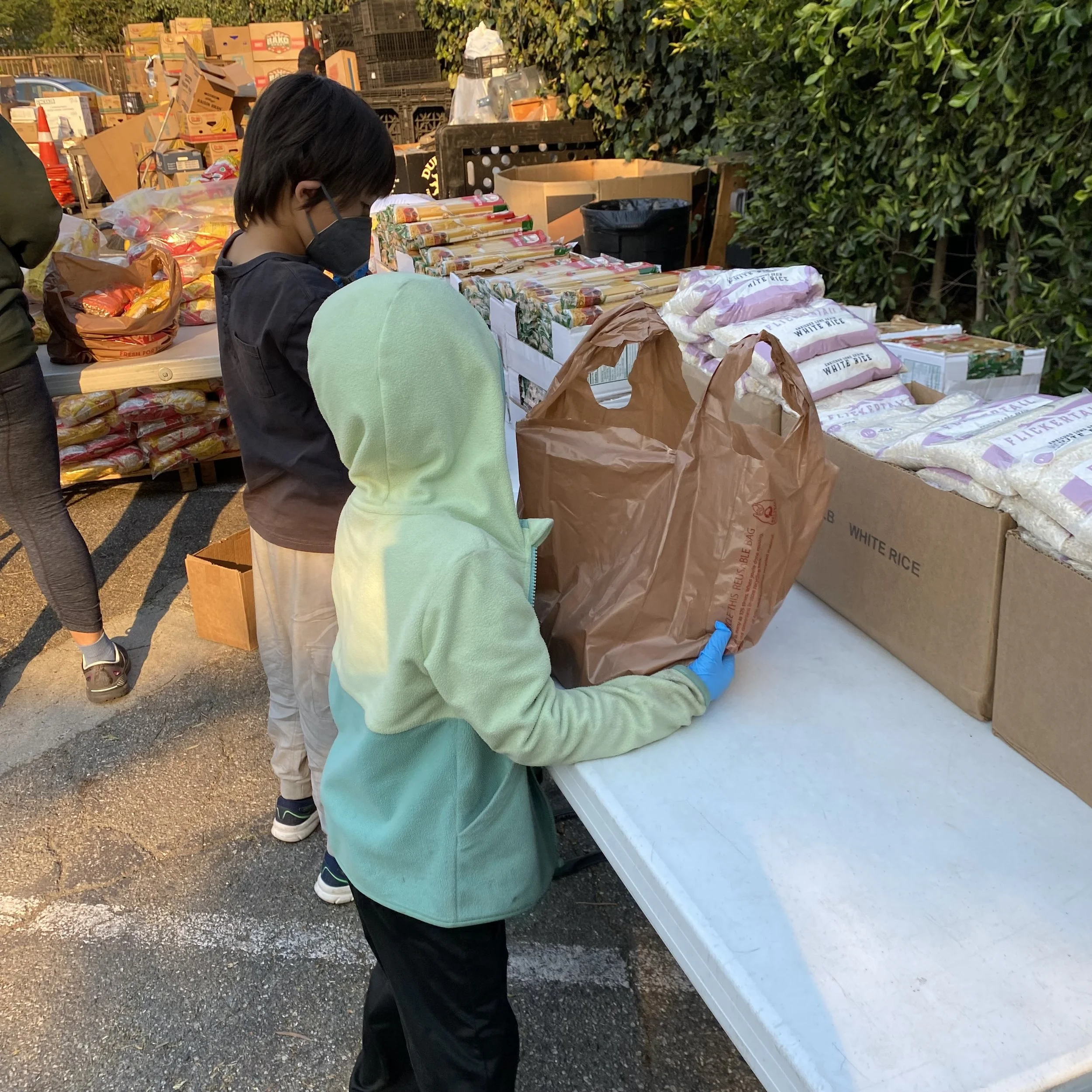 my kids volunteering at a local food bank in venice, california