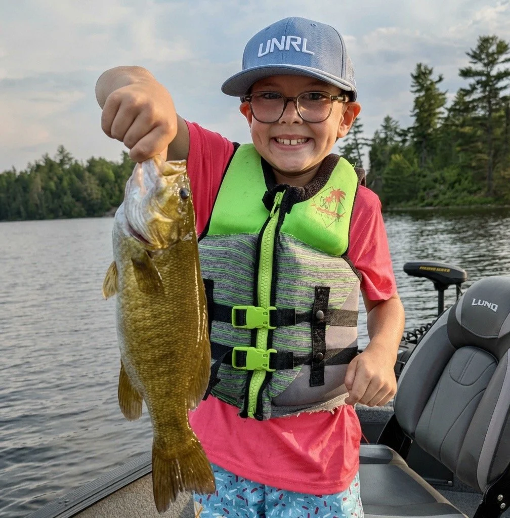 Young angler with nice smallmouth bass caught last week in the Ely area near BWCA. Arrowhead Outdoors fishing report.