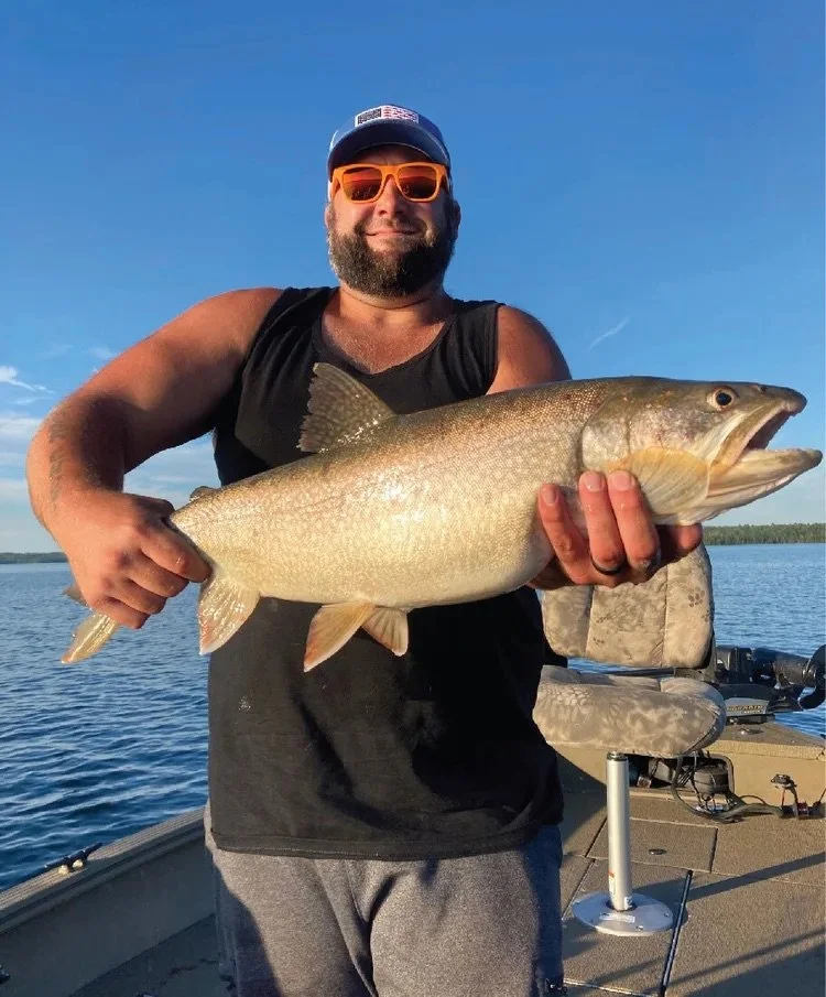 Ely MN BWCA smallmouth bass open water catch June 16 2021, young angler holding bronze smallie at sunset on boat, Arrowhead Outdoors report