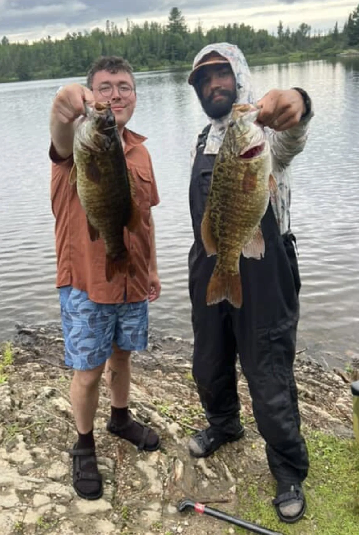 Anglers hold trophy smallmouth bass on wacky rig Berkley Trilene YUM Worm VMC Hook Ugly Stik July 29, 2025 in Ely MN BWCA. Summer report from Arrowhead Outdoors.