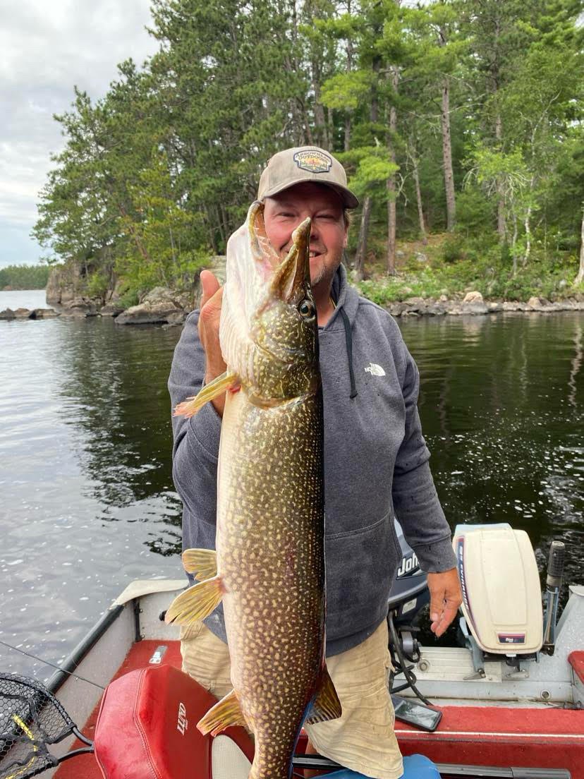 Angler holds northern pike caught on pike sucker in boat Ely MN, BWCA area, September 24 2024. Arrowhead Outdoors Ely MN fishing report with premium tackle, hunting gear & camping supplies available.
