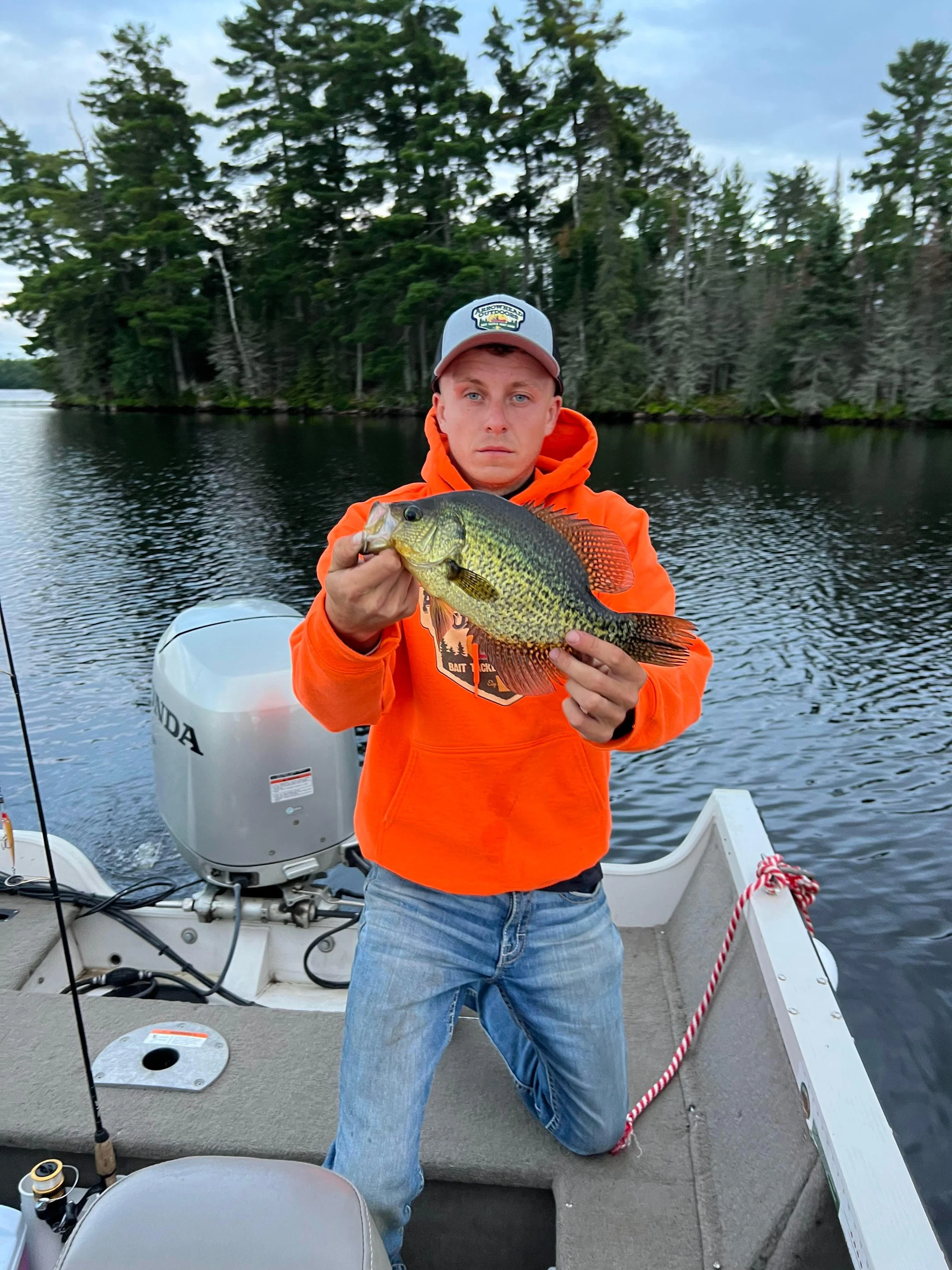 Ely MN BWCA crappie catch in Arrowhead Outdoors fishing report August 22 2023 – young angler holding golden slab on boat calm lake
