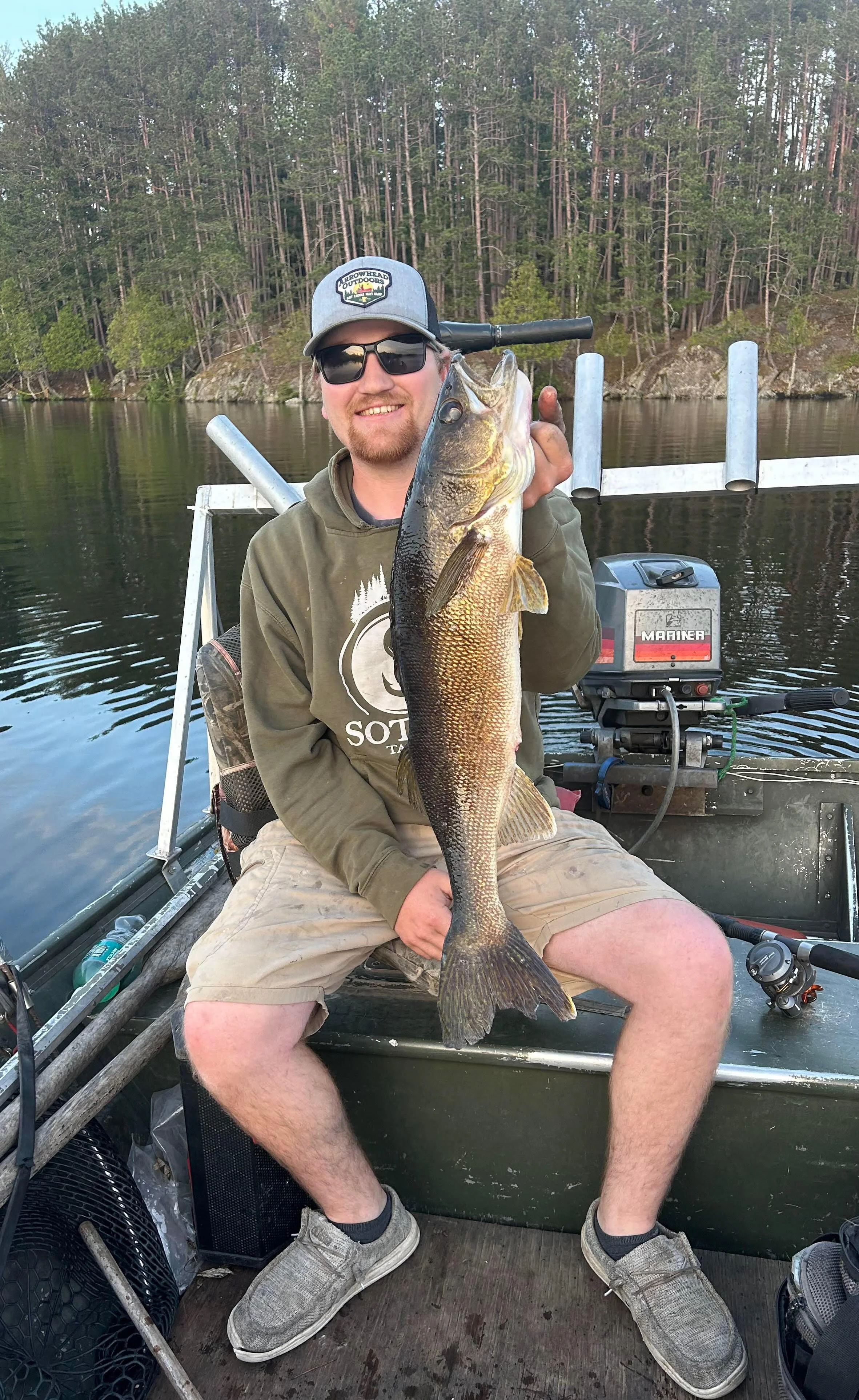 Angler holds walleye caught on juicy leech in boat Ely MN, BWCA area, July 9 2024. Arrowhead Outdoors Ely MN fishing report with premium tackle, hunting gear & camping supplies available.