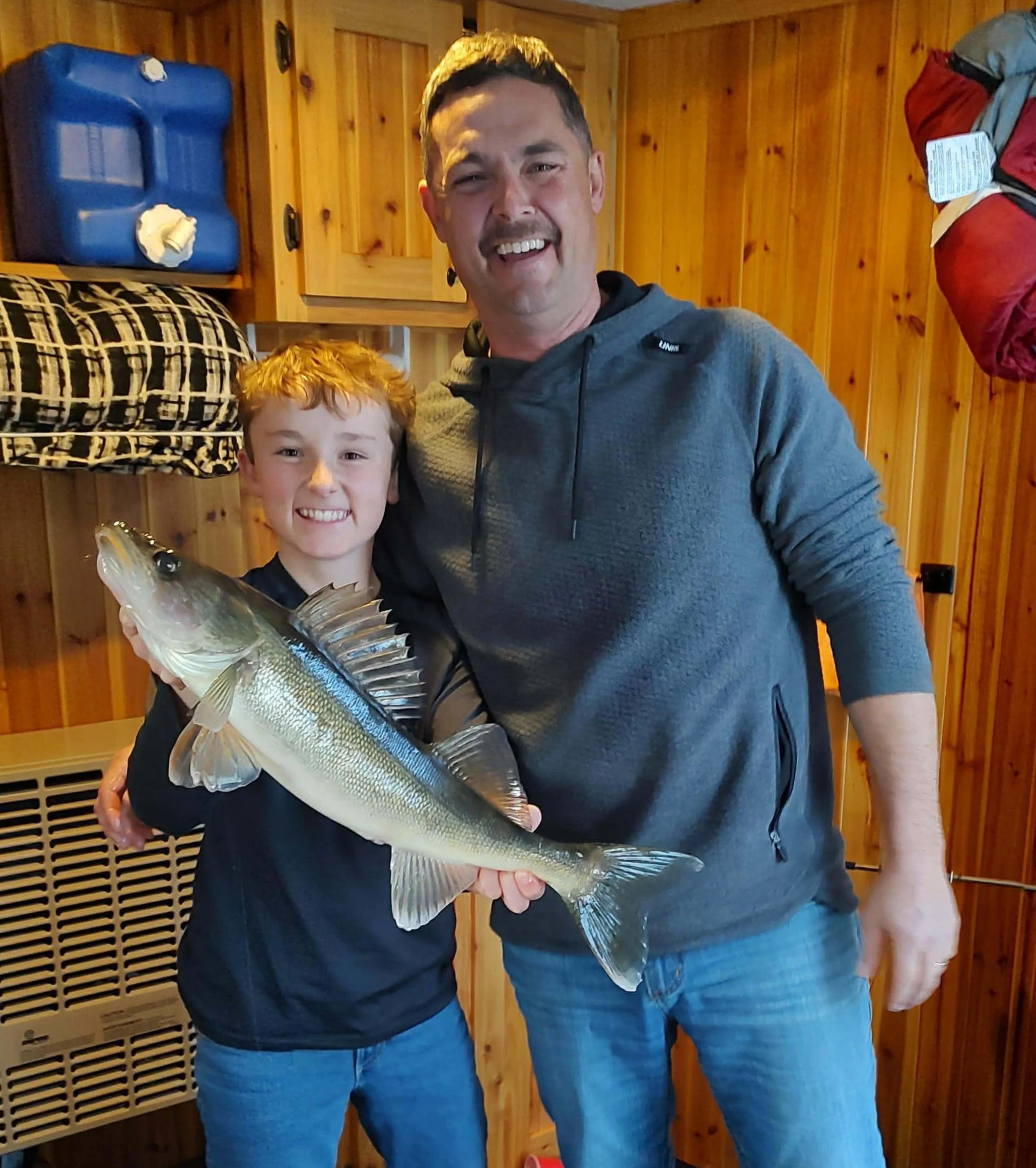 Father and son with nice walleye caught ice fishing Ely MN BWCA Farm Lake December 2025