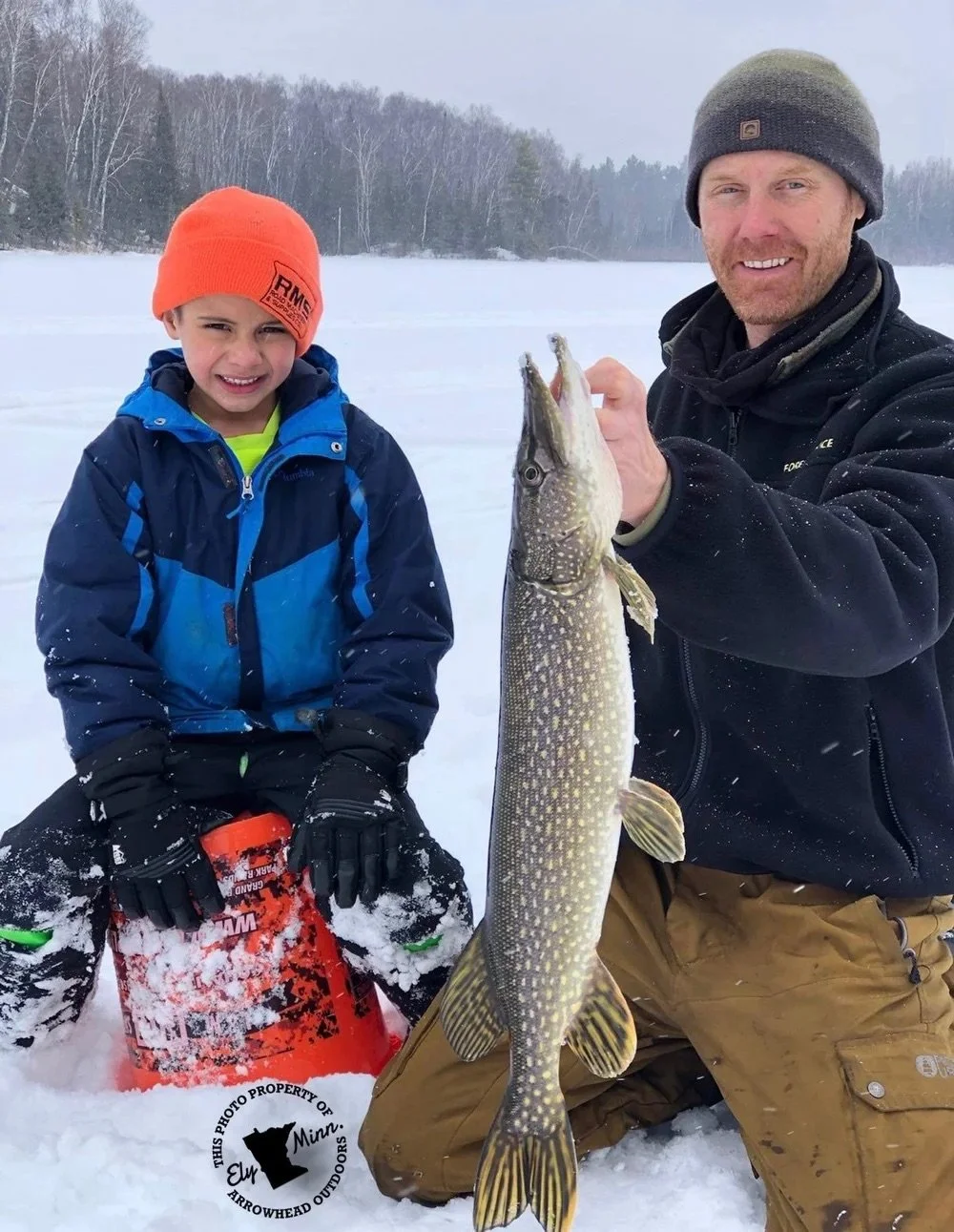 Tip-up setup on early ice for northern pike in Ely MN BWCA waters from Arrowhead Outdoors December 15 2021 fishing report showing frozen lake weedbed spots shallow bays snow-covered scenery and winter Northwoods gear for hot pike action