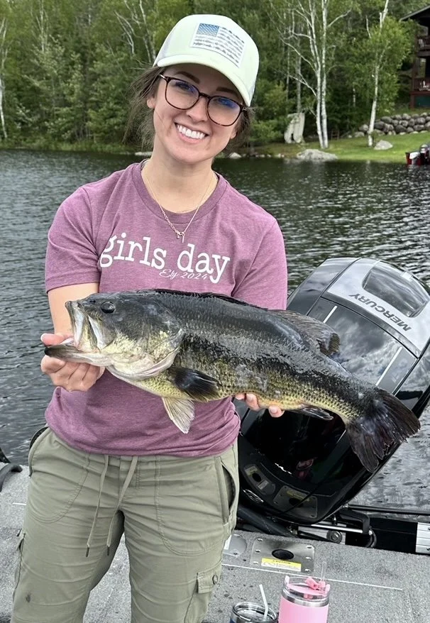 Angler holds giant largemouth bass off dock Ely MN, BWCA area, September 17 2024. Arrowhead Outdoors Ely MN fishing report with premium tackle, hunting gear & camping supplies available.