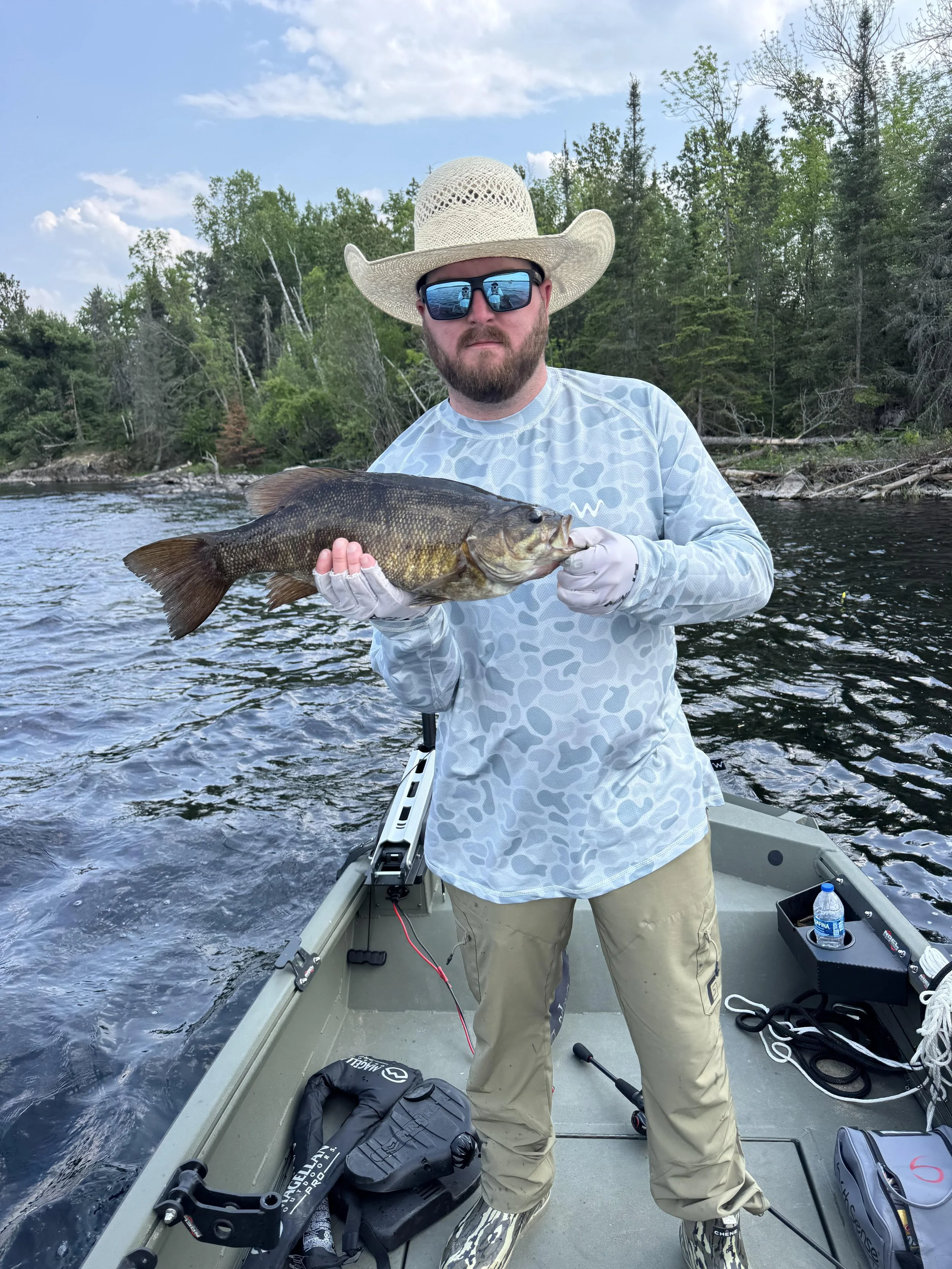 Angler holds smallmouth bass on VMC Spinnerbait July 8, 2025 in Ely MN BWCA. Summer report from Arrowhead Outdoors.