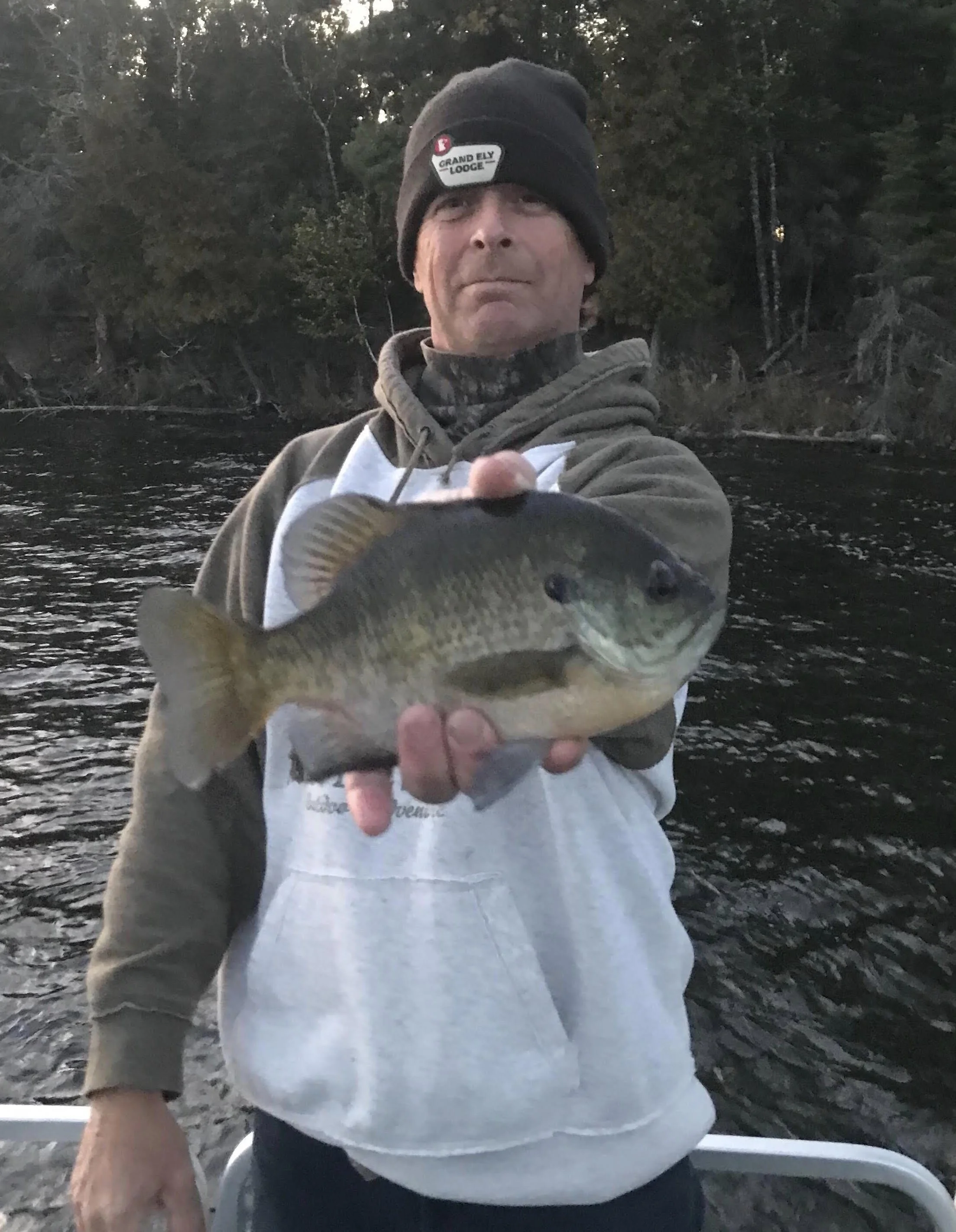 Angler holds plump bluegill panfish in boat at dusk on Ely MN water, BWCA area, September 26 2023. Arrowhead Outdoors Ely MN fishing report with premium tackle, hunting gear & camping supplies.