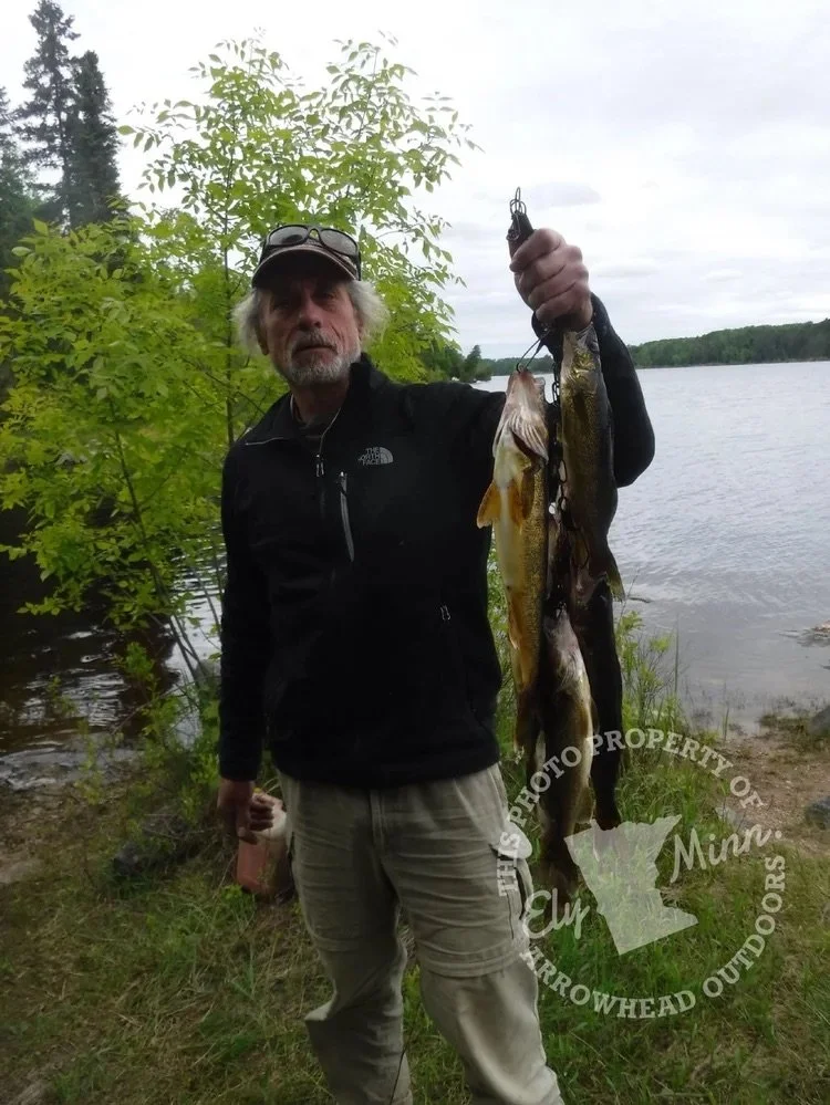 BWCA trophy walleye Ely MN woman angler - Big walleye boat hold Boundary Waters Arrowhead Outdoors report