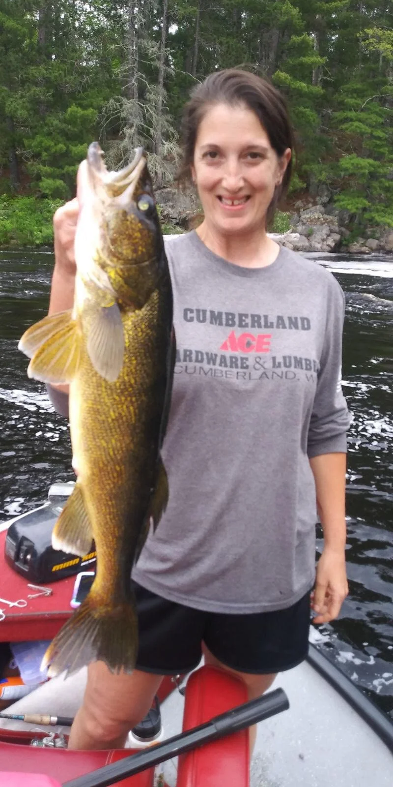 Angler holds walleye caught on pike sucker in boat Ely MN, BWCA area, June 18 2024. Arrowhead Outdoors Ely MN fishing report with premium tackle, hunting gear & camping supplies available.