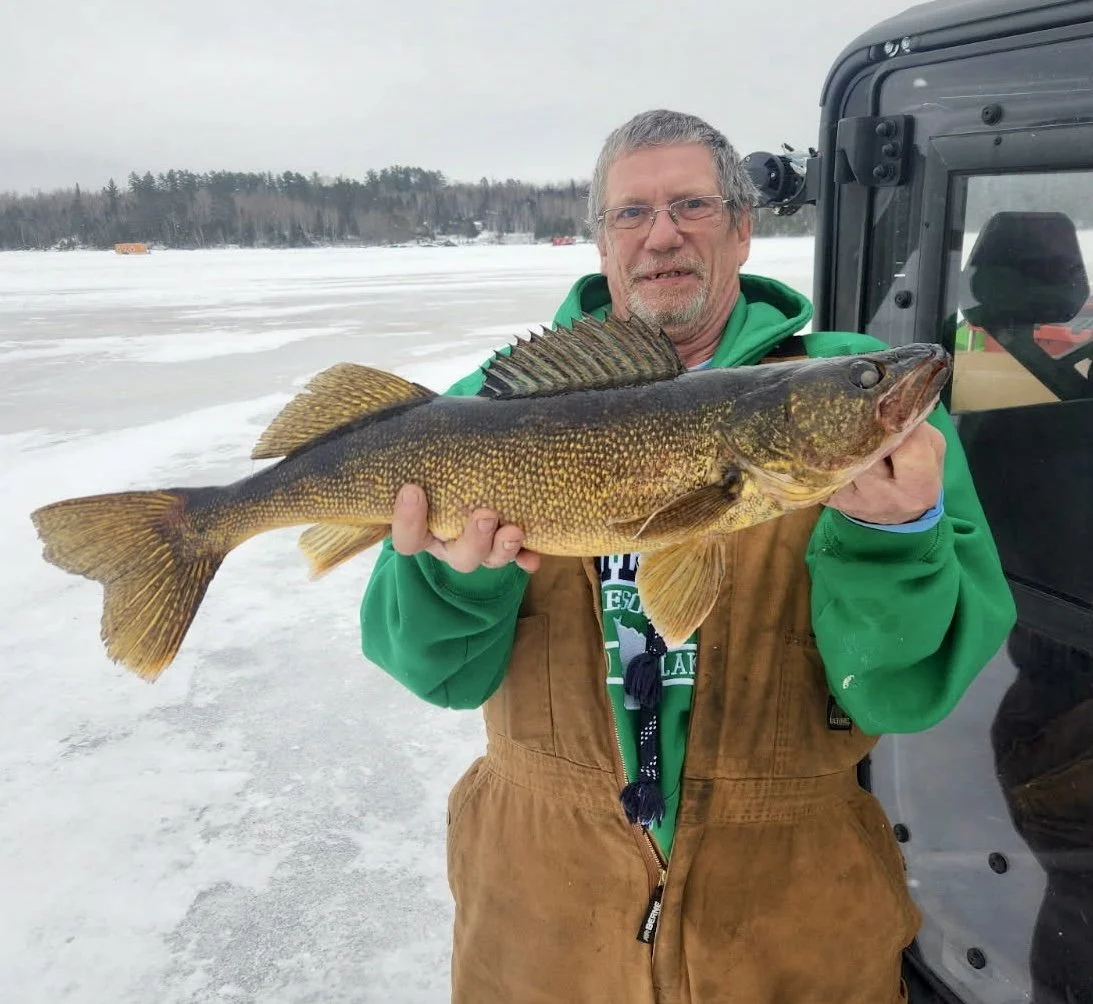 Angler holds giant walleye caught on shiner February 5, 2025 on ice in Ely MN BWCA. Winter fishing report from Arrowhead Outdoors