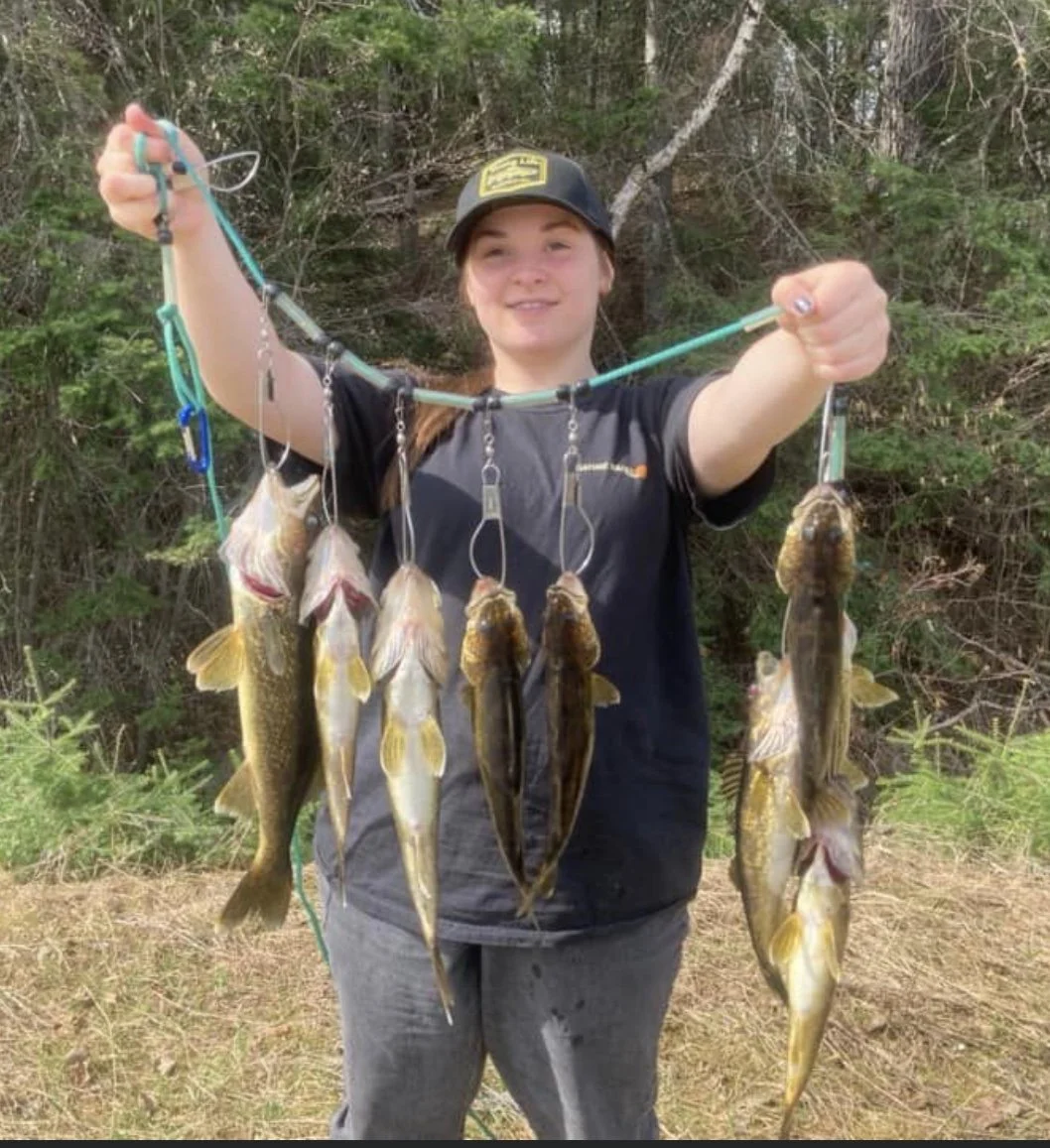 Ely MN BWCA walleye catch in Arrowhead Outdoors fishing report May 16 2023 – young angler with stringer haul in Northwoods pines