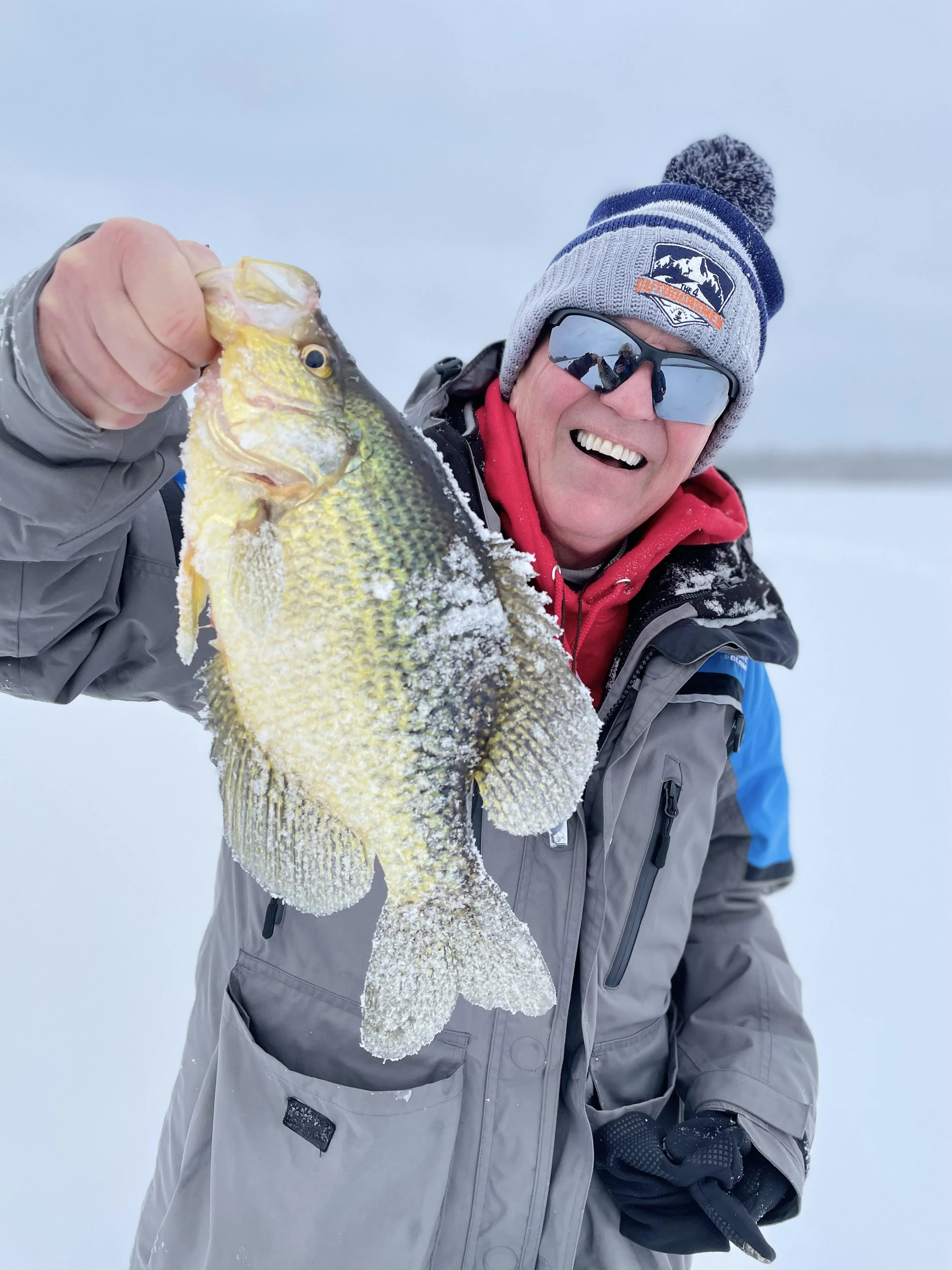 Steve "Stru" Strusinski from The 4 Outdoorsmen holds slab crappie on ice February 26, 2025 in Ely MN BWCA. Winter report from Arrowhead Outdoors.