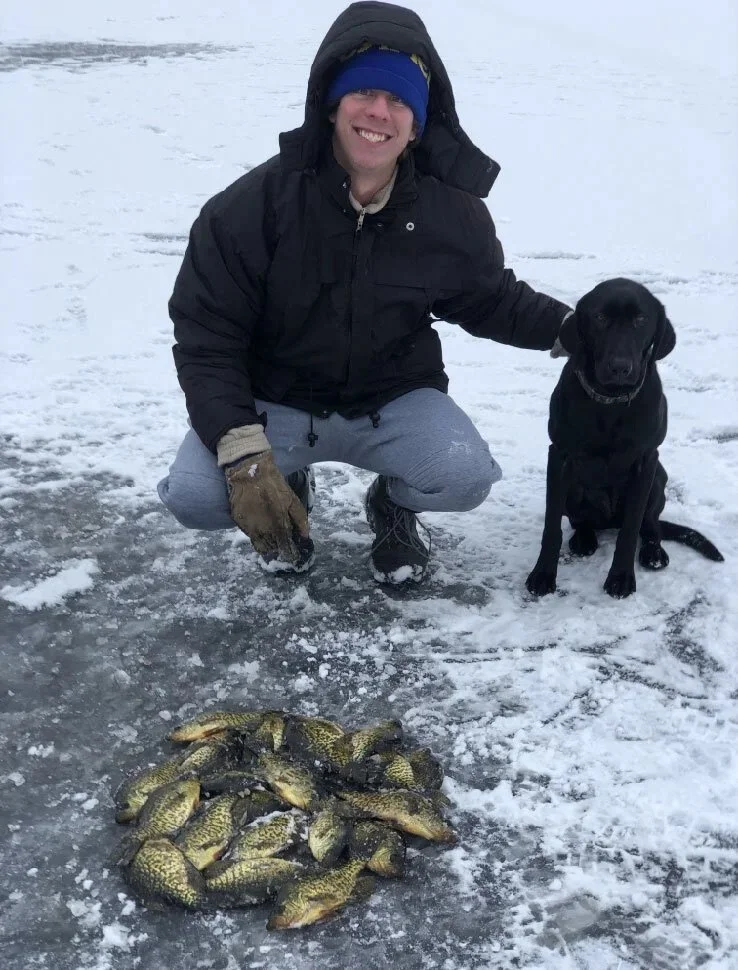 Ely MN BWCA crappie ice fishing catch with black lab and big slab pile on frozen lake, Arrowhead Outdoors report January 26 2021